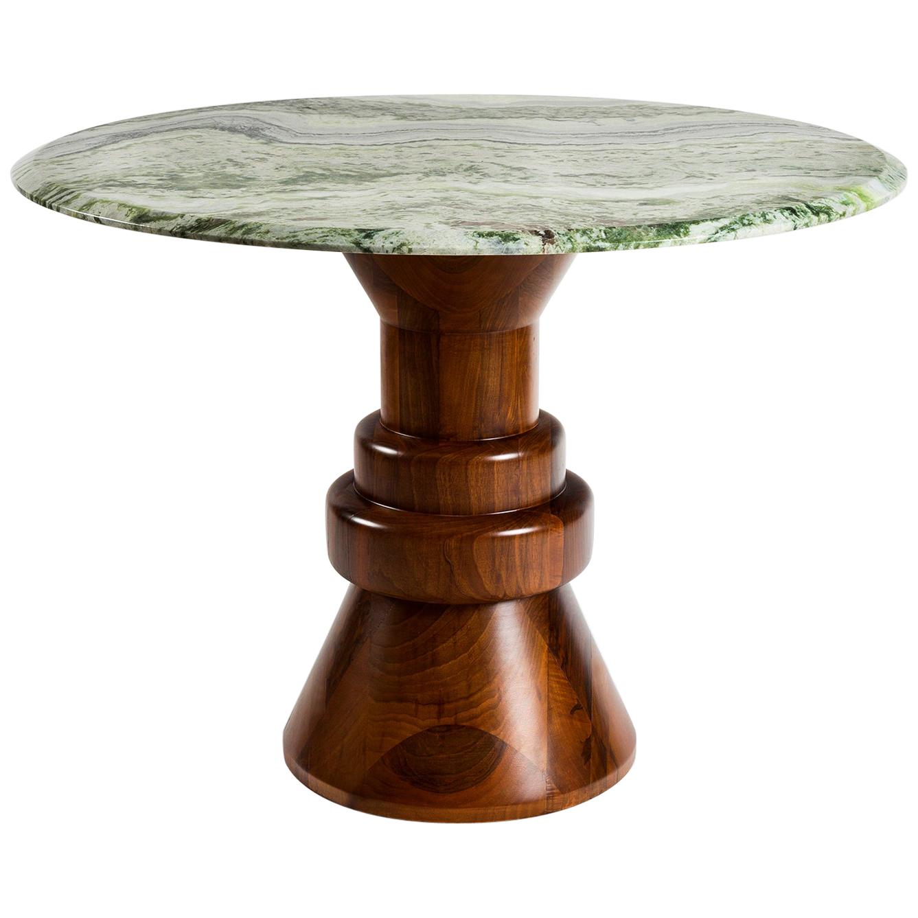 This playful handcrafted dining table is perfect to accommodate 4 people in smaller spaces. Cream/gray marble top is combined with sculptural black finished wooden base and can be customized in different sizes and marble tops.