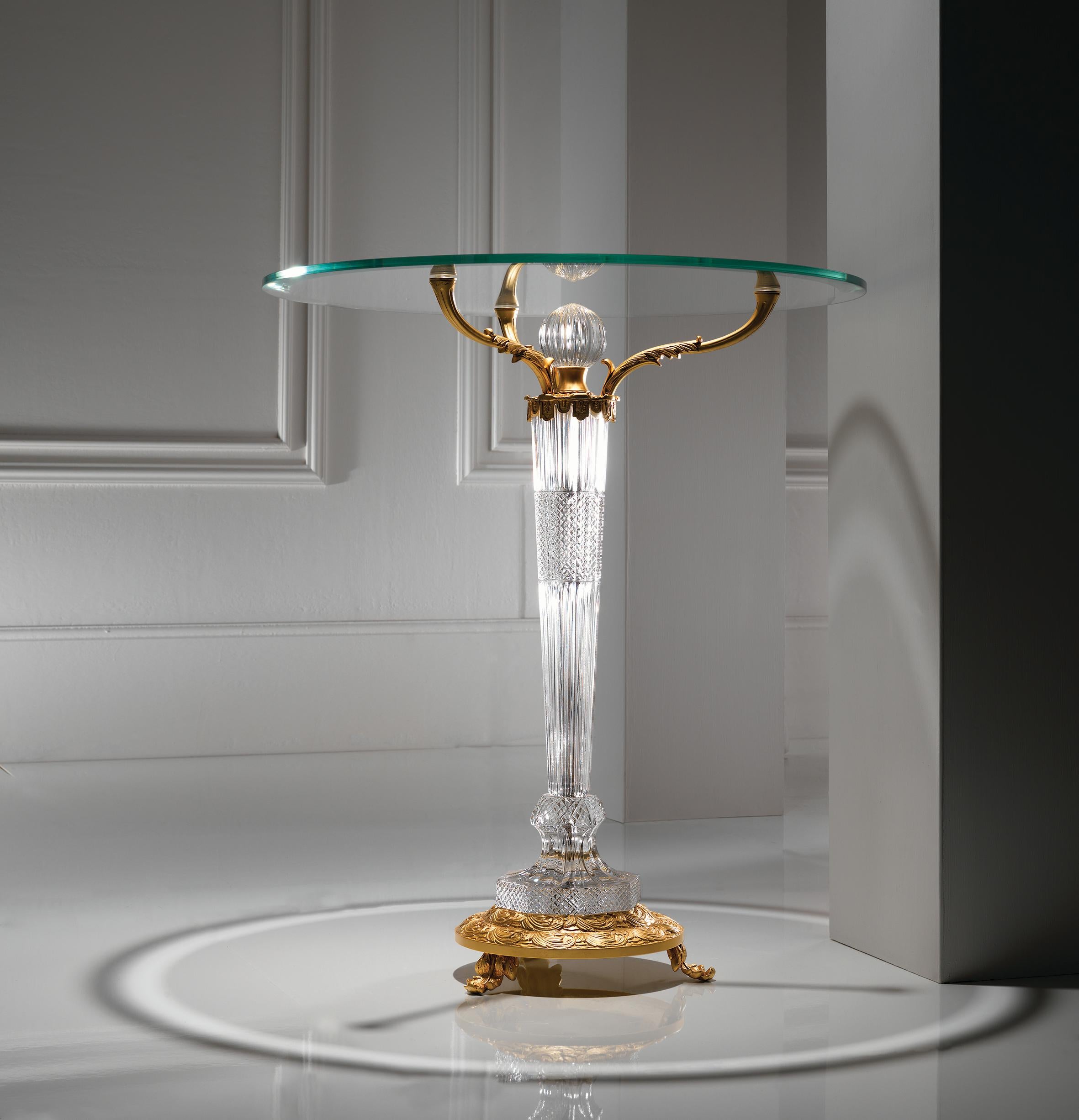 Clear crystal and French gold bronze side table with one legs and the temperated glass top. The parts in crystal are hand-carved. Each object is handcrafted and the care for every detail makes each item unique in its kind. The style of this side