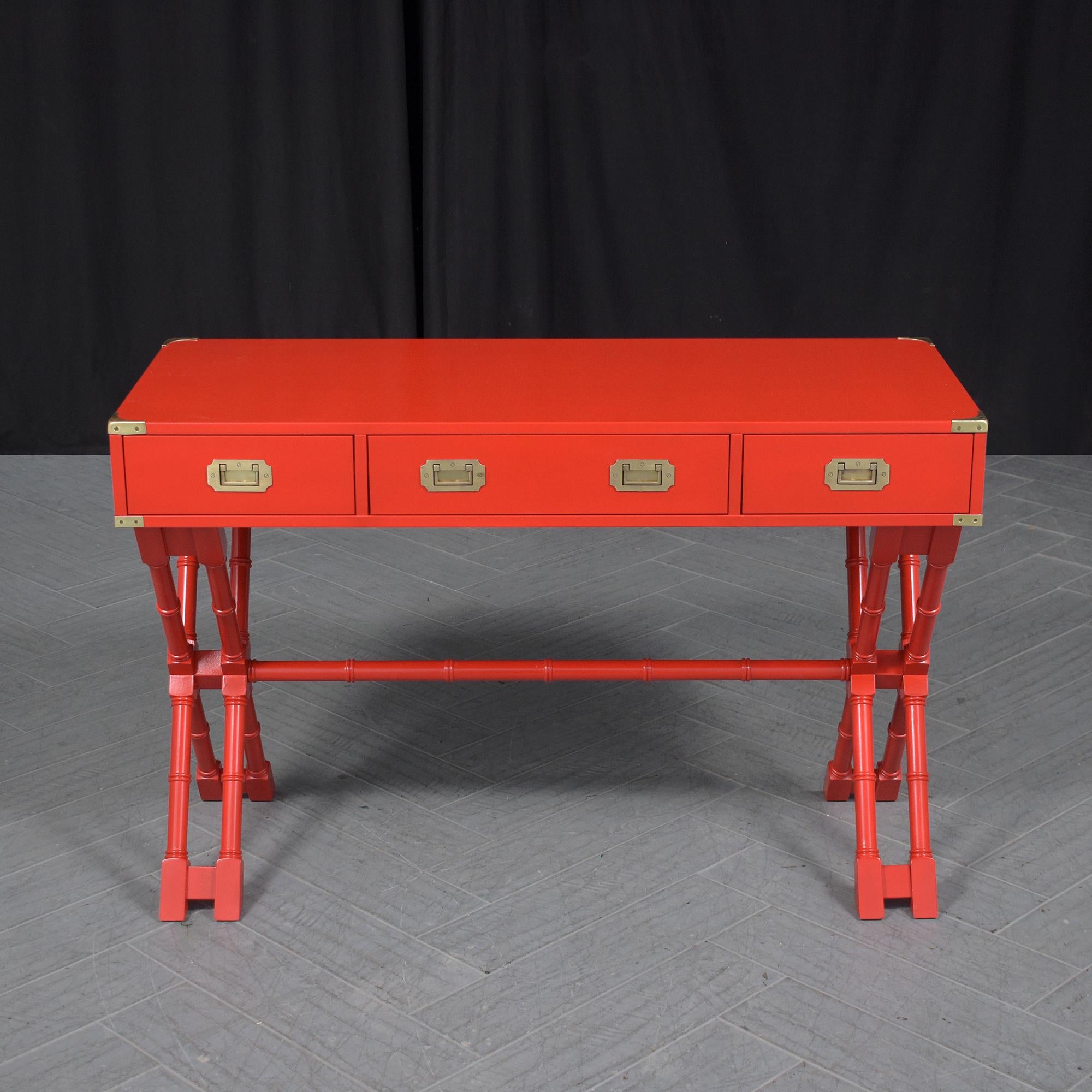 Enhance your work or home office with our stunning 21st-century campaign desk, beautifully restored and refinished by our professional craftsman team. This desk is a perfect blend of style and functionality, featuring a vivid custom red color that