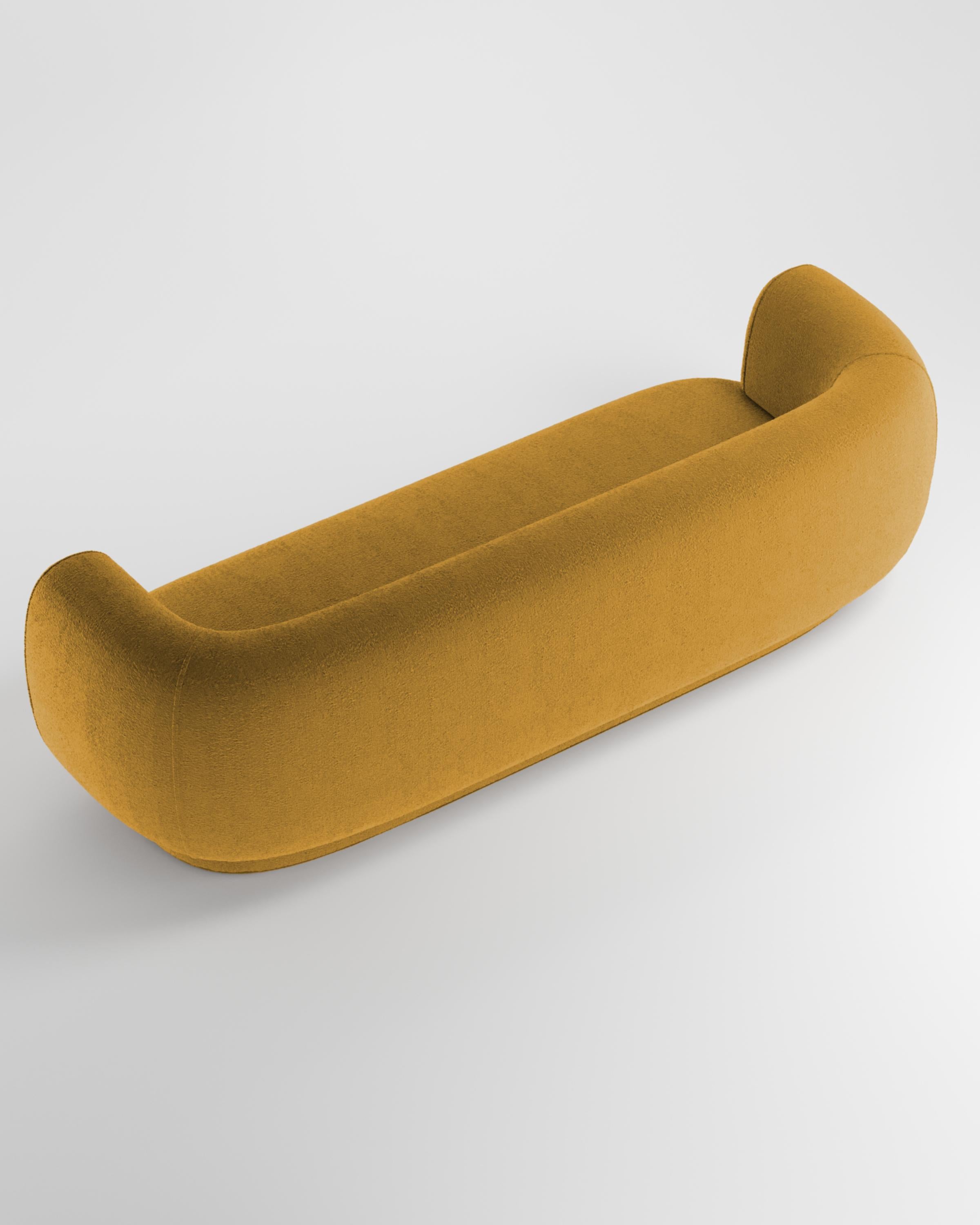 Hug sofa is defined by clean, simple lines and a distinctive armrest detail.
The armrest, half overlapping the seat cushion, creates an interlocking detail between the two elements, while the padding, firm and welcoming at the same time,