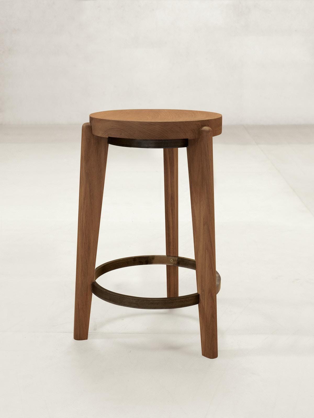 21st Century designed counter stool teak wood brown metal.

The counter stool or round stool has a solid teak seat with two metal rings - one at the foot of the stool and a smaller ring supporting the seat. The seat is gently hollowed to make