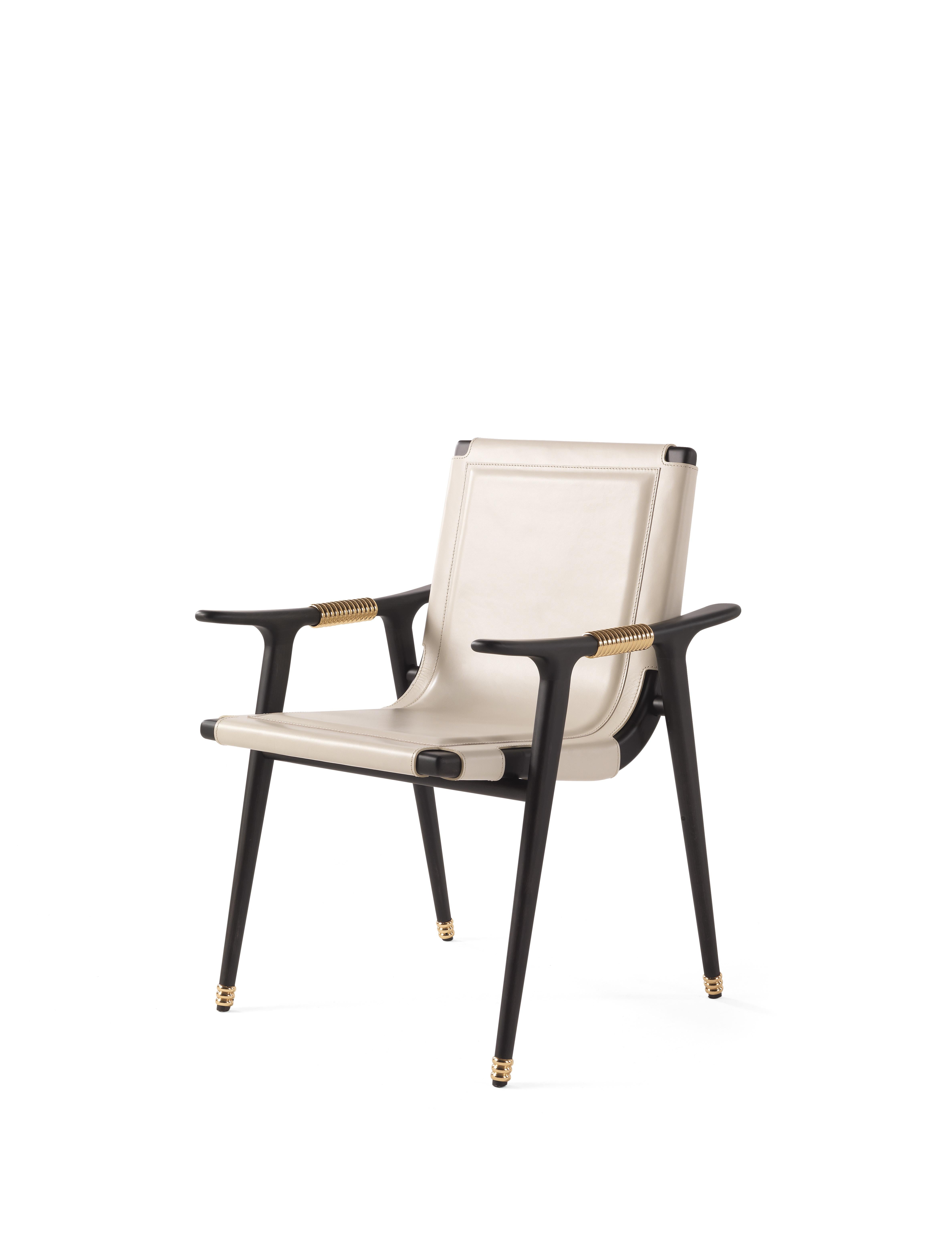 Dinka is a chair full of fascinating details and evocative references.
The precious upholstery in ivory saddle leather features special eyelets lace-up on the back.
The structure with matt dark wengè dye is enriched by polished brass rings,