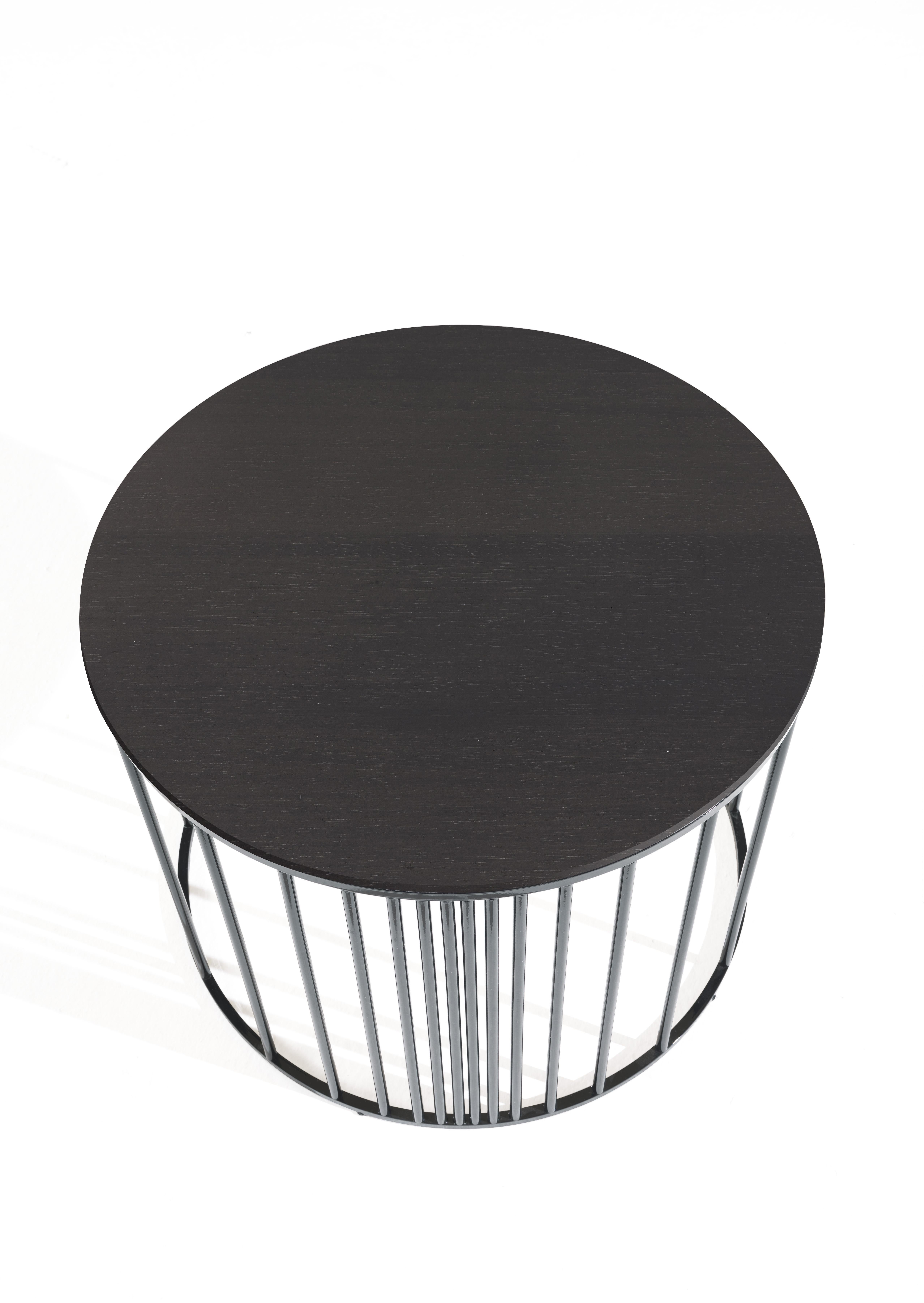 Versatile and eclectic, Doppler small table is characterized by a round top in multilayer wood veneered in Tay Dyed Smokey Grey, supported by a light structure with cylindrical cross-sections with black finishing. Available in different heights and