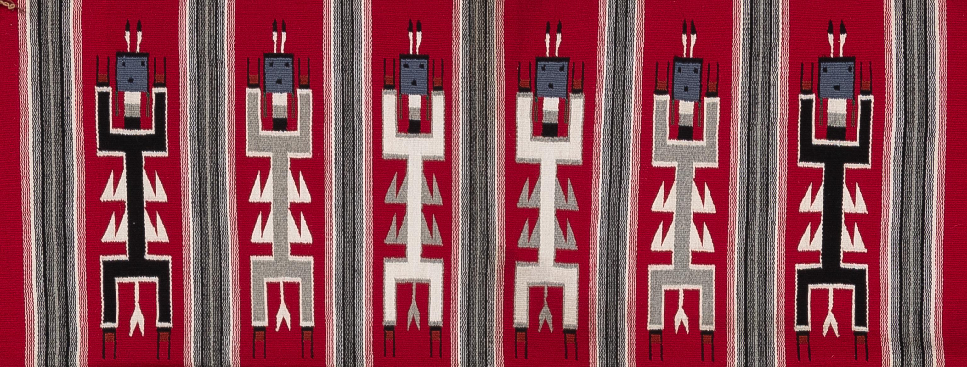 Introducing a captivating Dragonfly Yei rug, crafted circa 2000, that beautifully blends traditional motifs with contemporary techniques. This remarkable piece features Yei figures adorned with the distinctive double wings of a dragonfly, visible