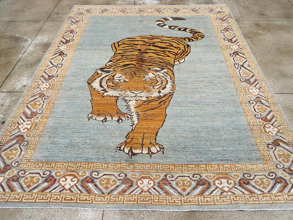 A modern East Turkestan Khotan pictorial room size carpet handmade during the 21st century.

Measures: 9' 4