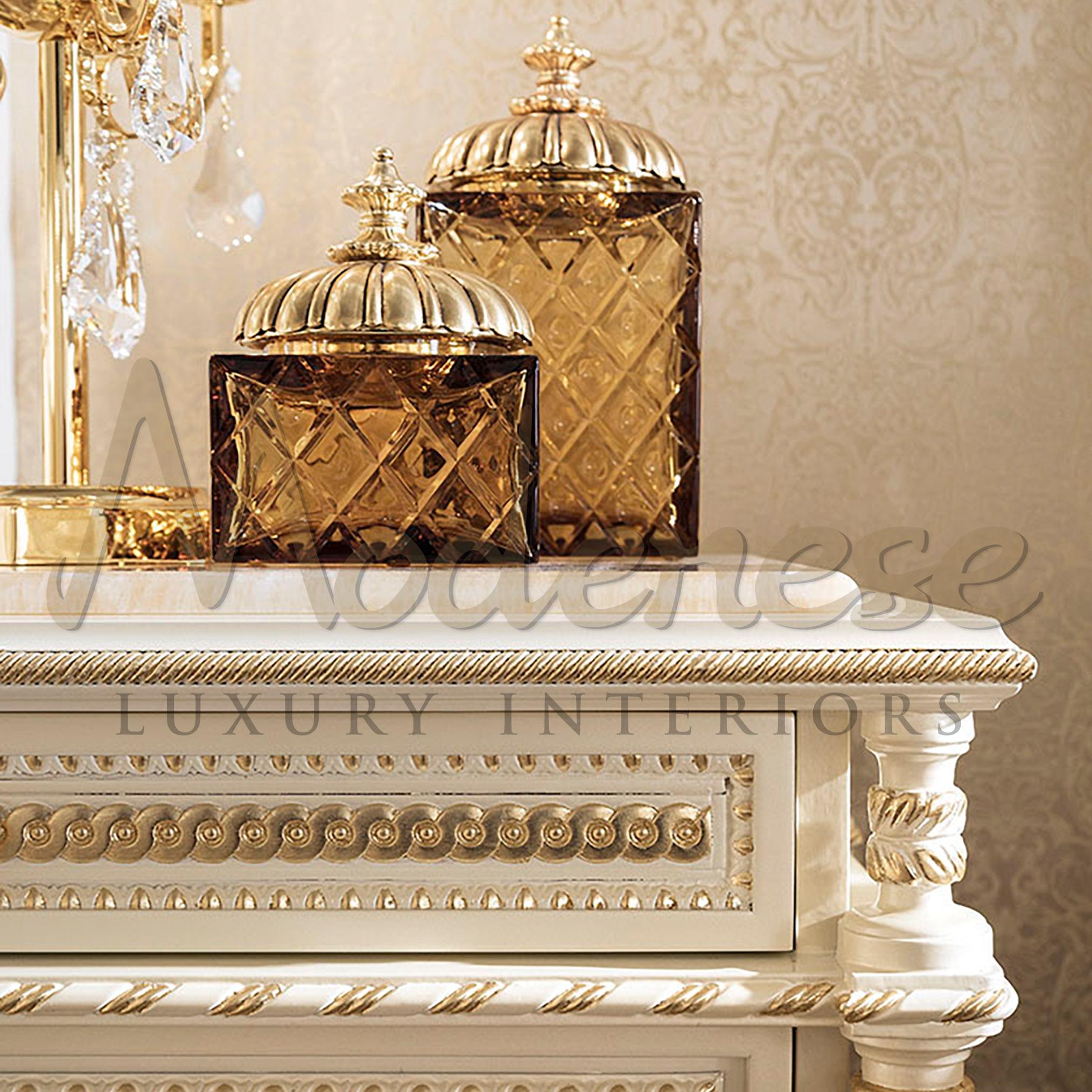 Luxurious empire-style dresser by Modenese Luxury Interiors, Italian furniture producer. Made of solid wood with white laquered finish and Honey Onyx top, plus empire-style wood carved columns, gold leaf details and golden knobs.
The Italian brand