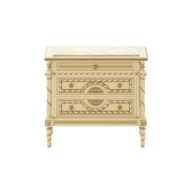 Exquisitely designed empire-stand night stand from Modenese Luxury Interiors, Italian classical furniture producer. Features an ivory finishing with gold leaf decorated details, plus a Crema Valencia marble top. As all Modenese bespoke furniture,