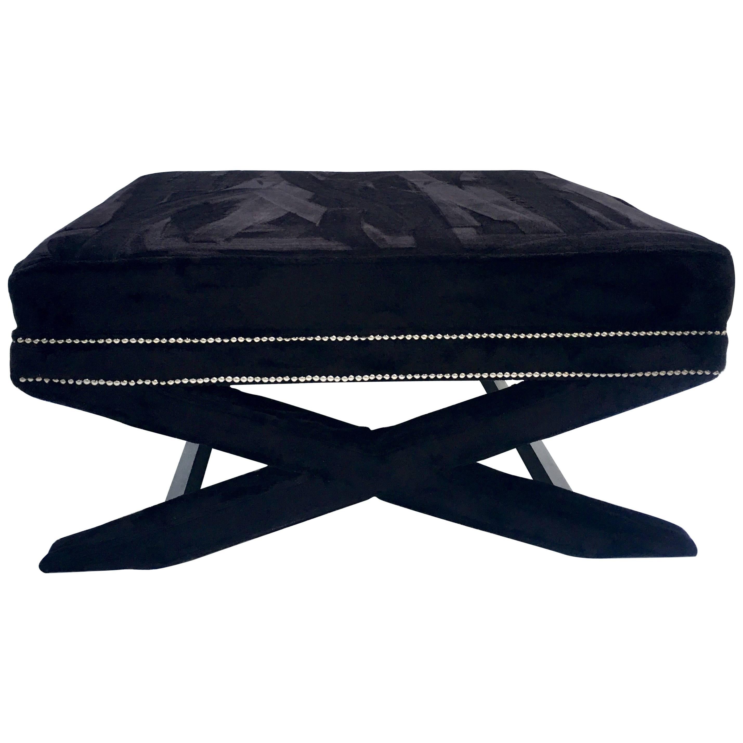 21st century modern faux jet black mink fur X-base ottoman/coffee table. This finely crafted and custom made piece is fabricated with a wood frame, upholstered in faux mink fur fabric and chrome nailhead detail. At 40.5