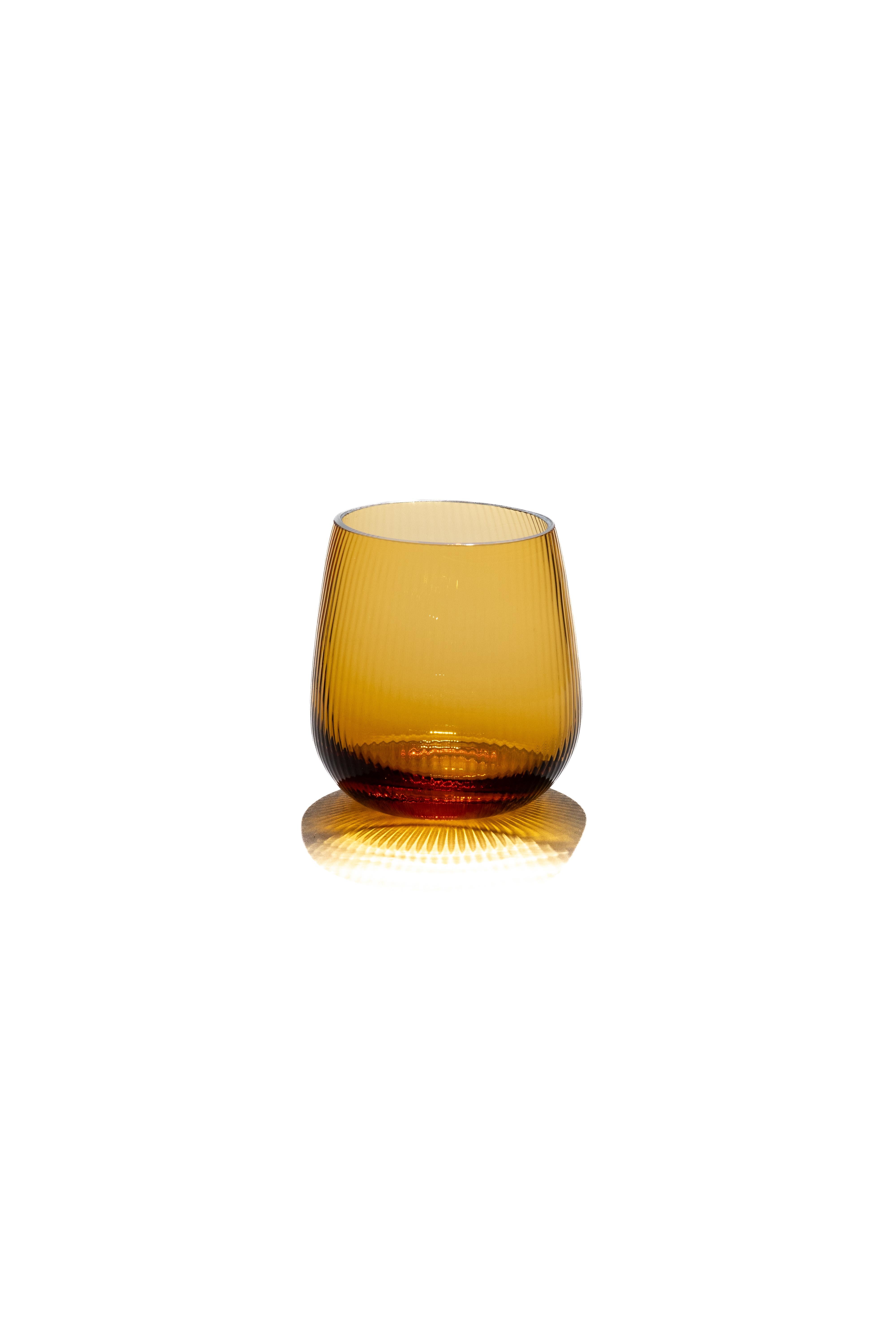 Stilla, the Latin word for a drop of water. Liquid, transparent, perfect. 
Federico Peri designed the Stilla Liquida glasses for Purho in spring 2024,  tumblers with textured surfaces and gentle, vaguely elliptical shapes, produced in two sizes,