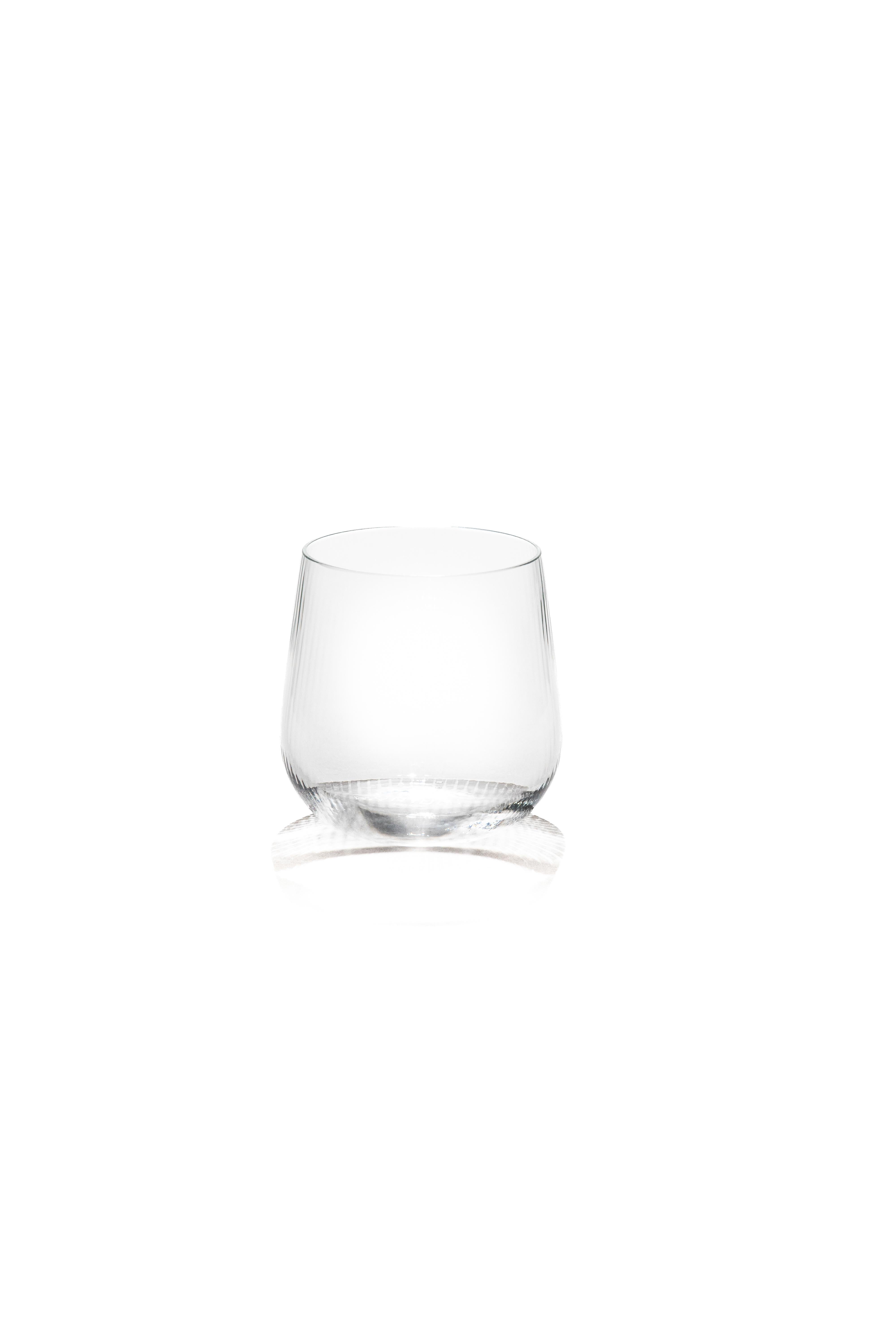 Stilla, the Latin word for a drop of water. Liquid, transparent, perfect. 
Federico Peri designed the Stilla Liquida glasses for Purho in spring 2024,  tumblers with textured surfaces and gentle, vaguely elliptical shapes, produced in two sizes,