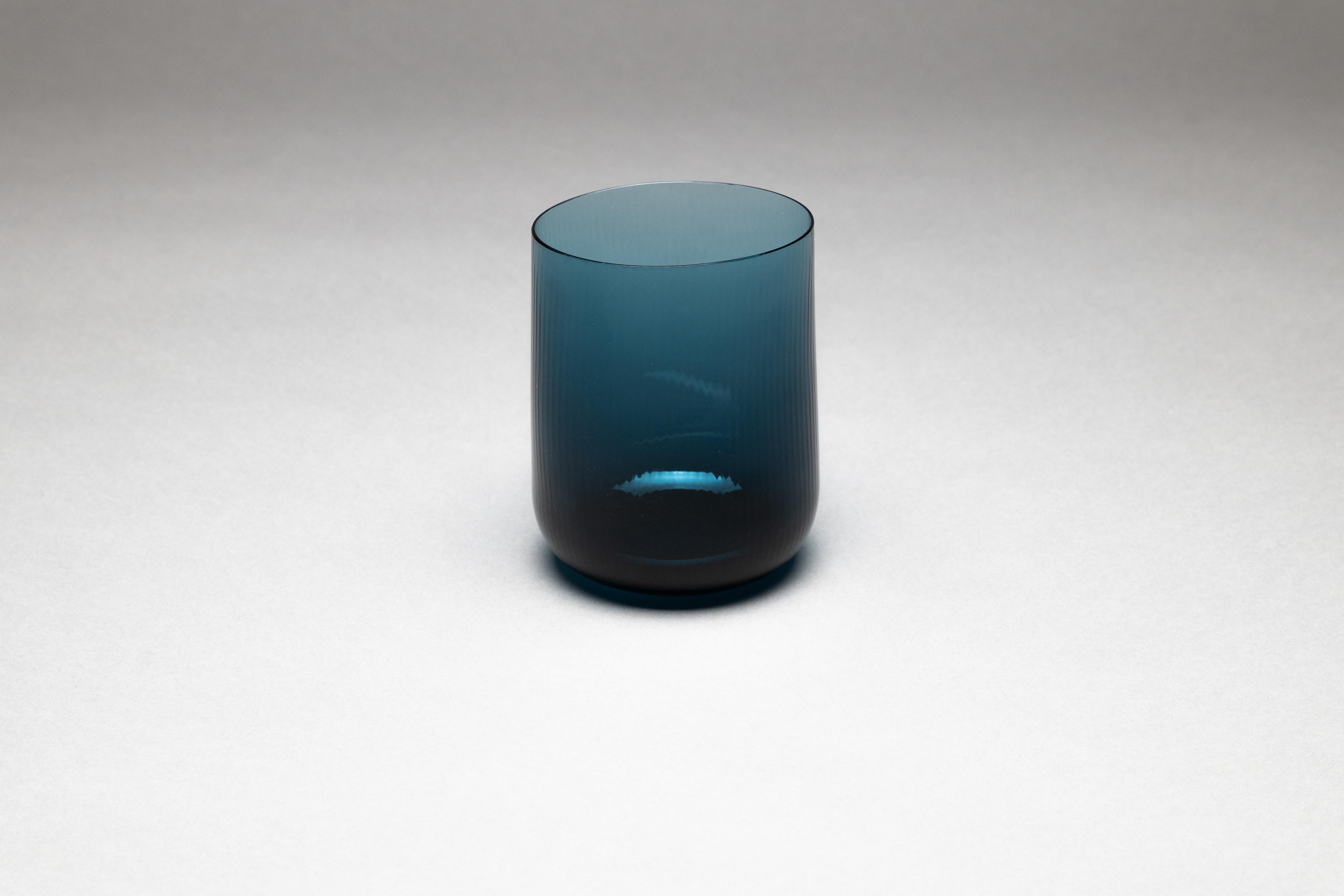 Stilla, the Latin word for a drop of water. Liquid, transparent, perfect. 
Federico Peri designed the Stilla Liquida glasses for Purho in spring 2024,  tumblers with textured surfaces and gentle, vaguely elliptical shapes, produced in two sizes,