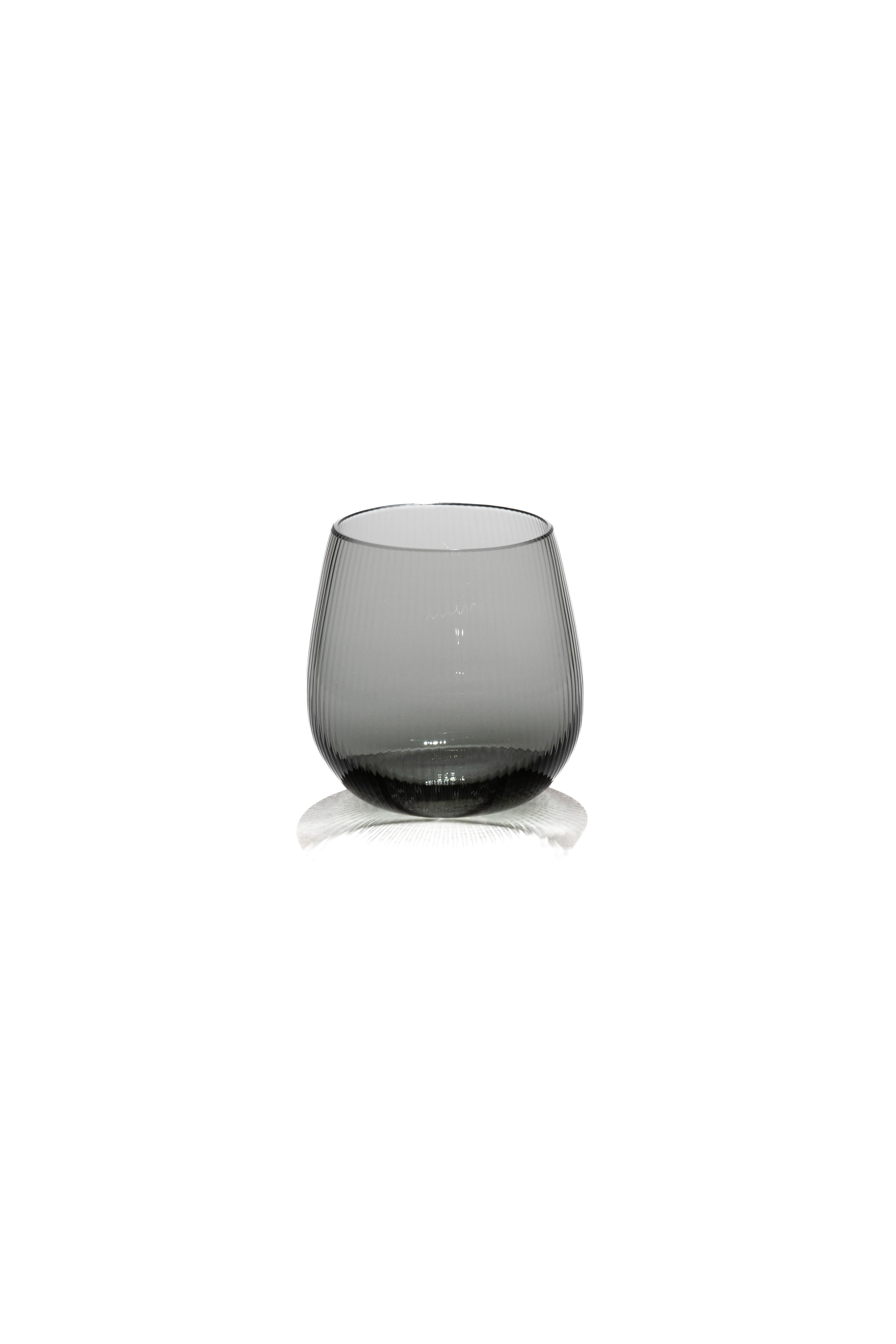 Stilla, the Latin word for a drop of water. Liquid, transparent, perfect. 
Federico Peri designed the Stilla Liquida glasses for Purho in spring 2024,  tumblers with textured surfaces and gentle, vaguely elliptical shapes, produced in two sizes,