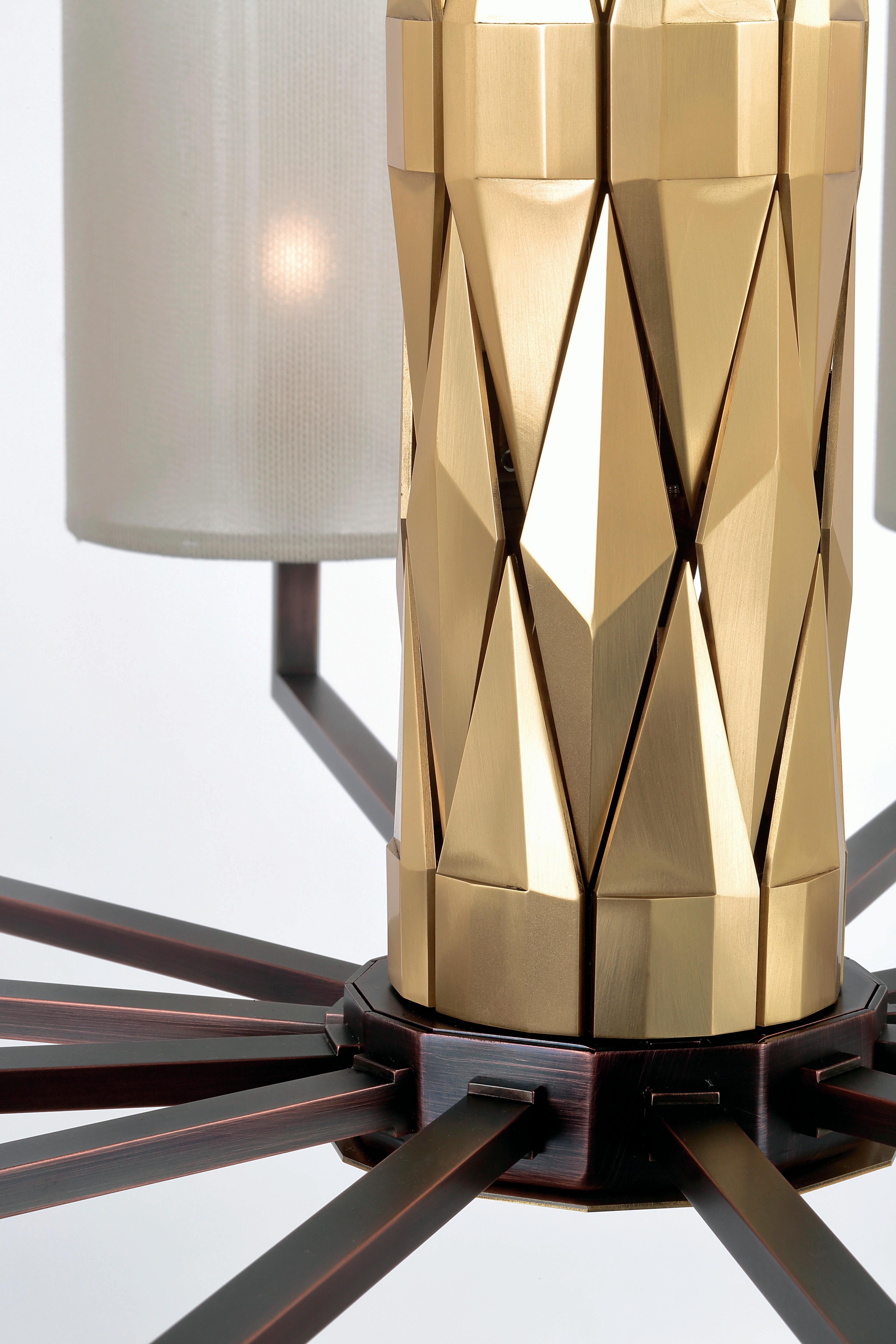 Flaire collection, rich central body composed of many solid brass elements, beveled in various ways for an array of facets.

Central structure and detailing in solid natural brass, lamp holders, base and inner structure in burnished copper finish.
