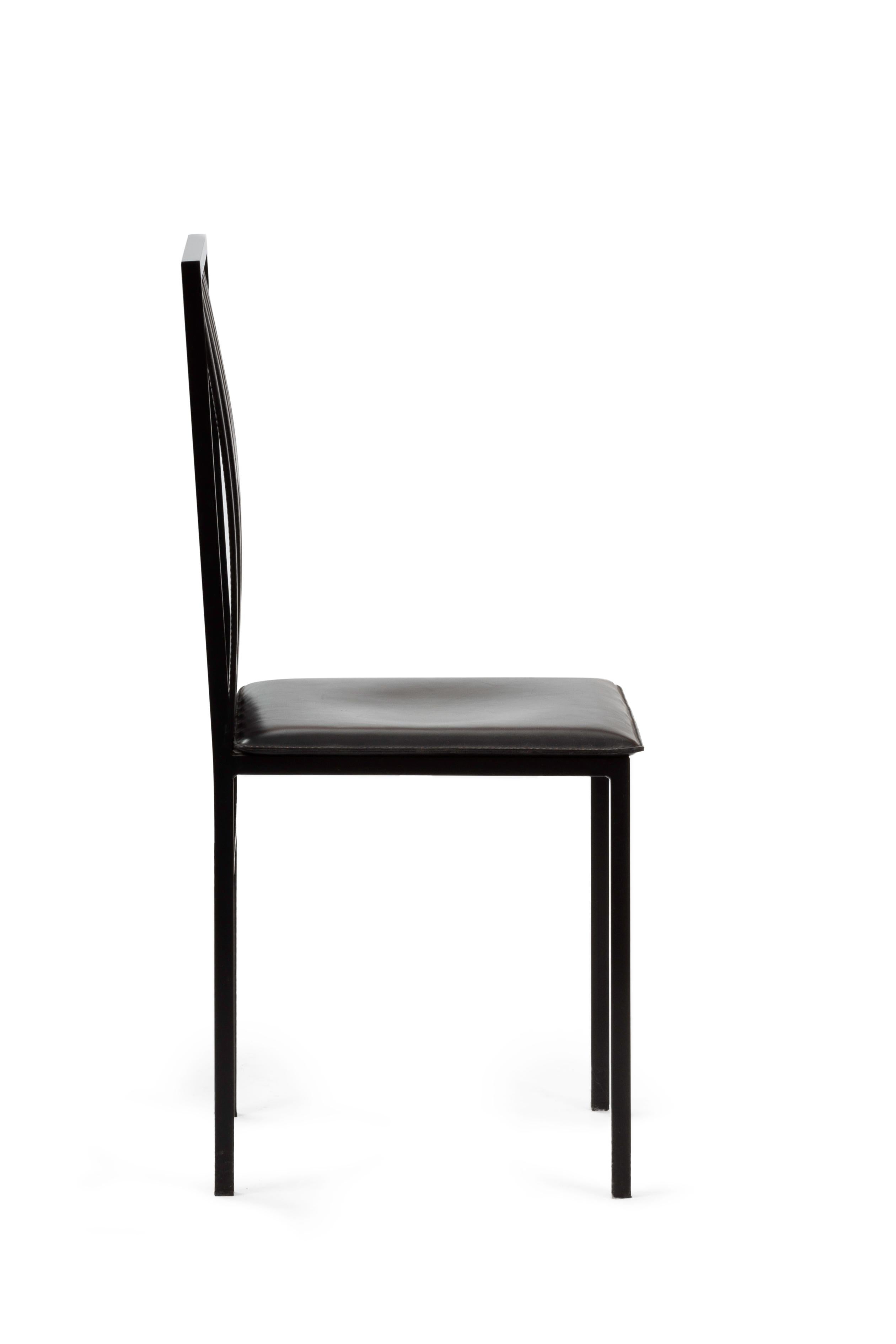 Painted metal and leather chair inspired by the elegant tailcoats of the 1940s. 
The slender black painted iron frame is characterised by a seductive spring steel back with convex vertical bars, upholstered in fine black leather. Seat upholstered