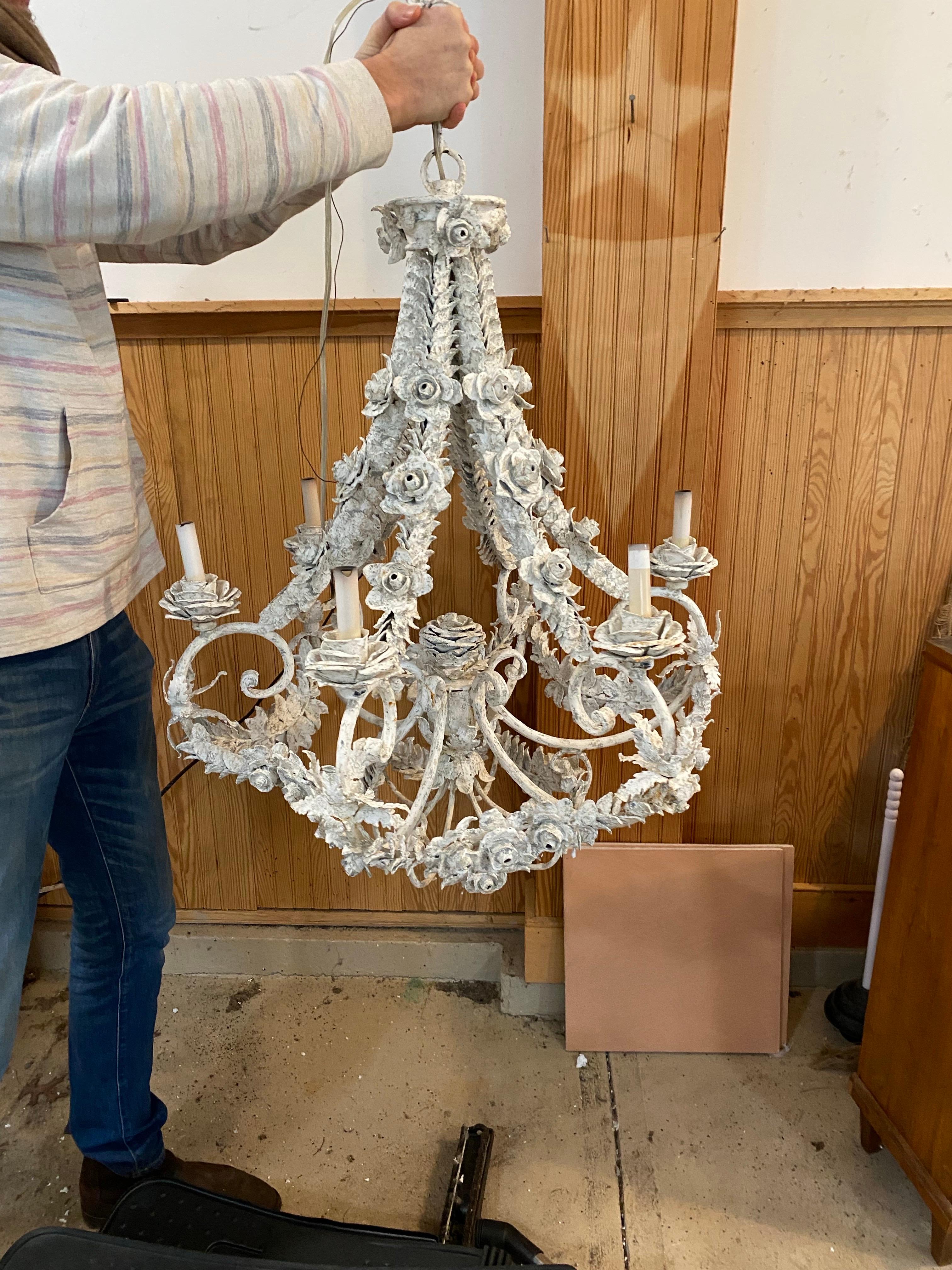 21st Century French Floral Metal Painted Chandelier 
This charming French country chandelier is crafted from metal and features a cascade of intricately detailed roses and leaves, all finished in a distressed white paint.  The six candle arms curve