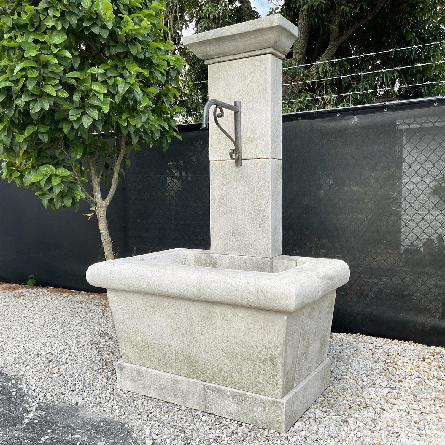 A very traditional Provencal wall fountain with a rectangular heavy water basin and a surmounting tower with a beveled cap. This type of fountain is still seen throughout the South of France. Minor fading, scratches due to age. Wear consistent with