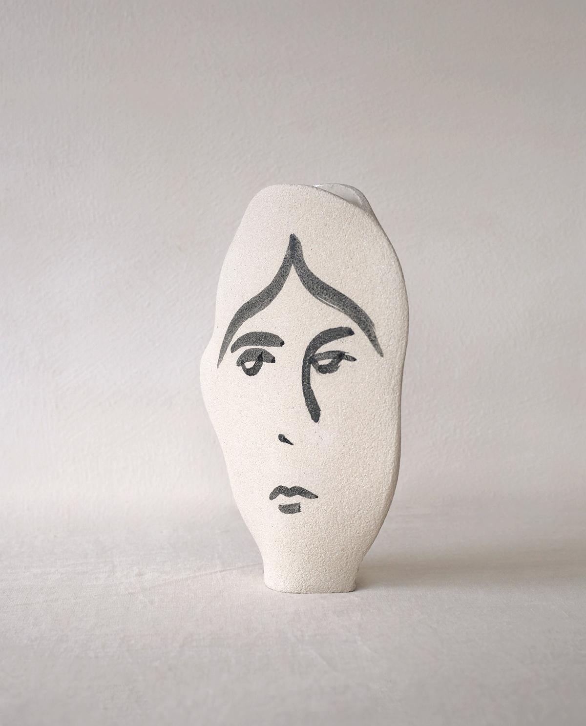 ‘Frida N°2’ Handmade Ceramic White Vase

This vase is part of a new series inspired by human faces and portrait illustrations. Here is a new shaped model, the ‘Frida N°2', with hand-painted figurative motifs applied with a brush before the first