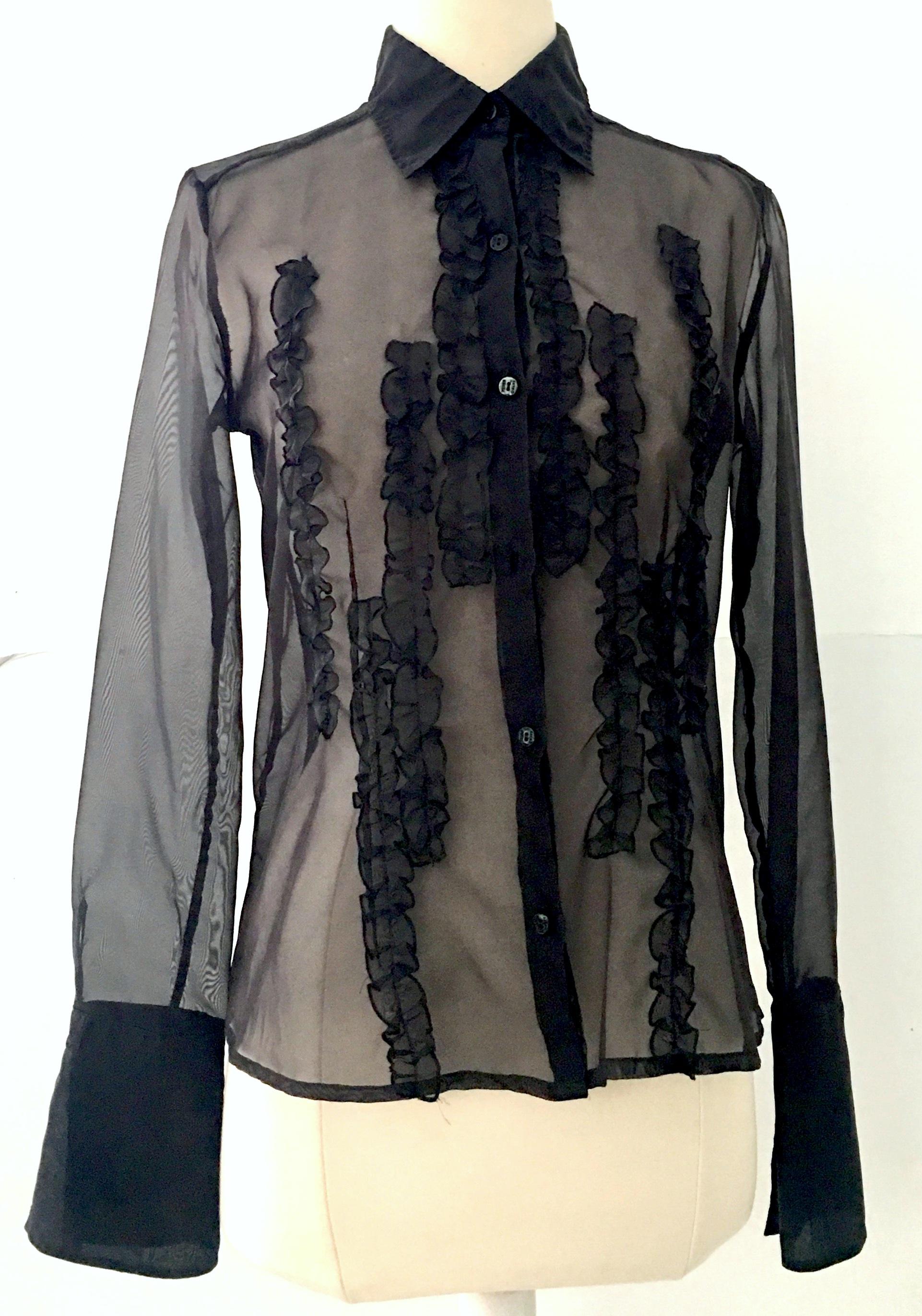 Classic Gianfranco Ferre black silk chiffon fitted ruffle front button up long sleeve blouse. Features Ginfranco Ferre logo buttons and french split sleeves.
The Gianfranco Ferre Jeans black and metallic gold label appears on the exterior side seam