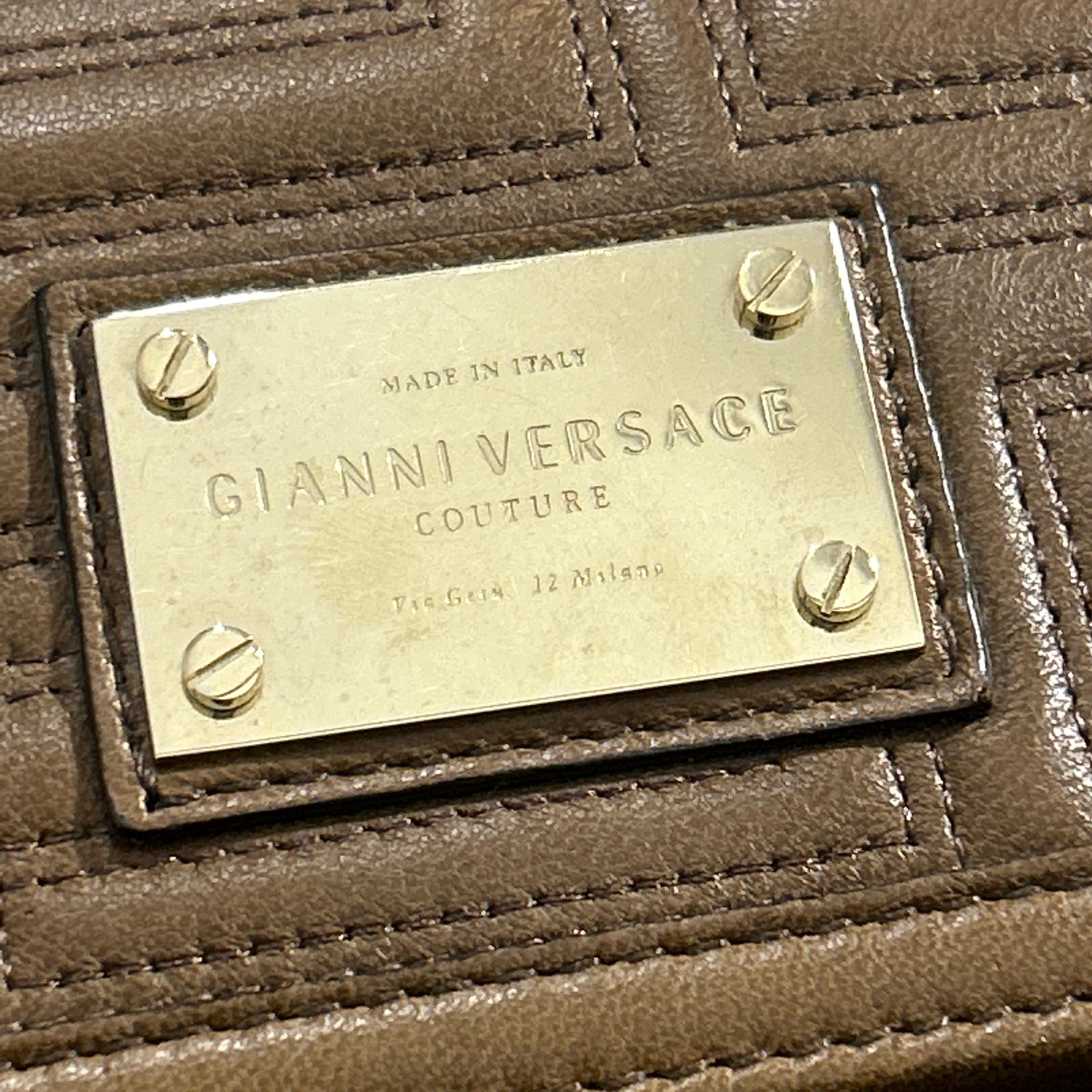 This exquisite mini shoulder bag from the Gianni Versace Couture collection is a masterpiece of luxury and design, embodying the bold elegance for which the brand is renowned. The bag features a structured, rectangular silhouette crafted from