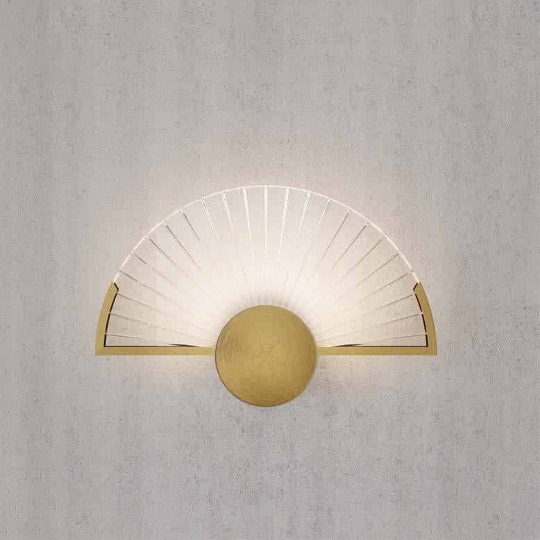 3-light  sconces in golden brass and ribed clear glass. Each object is handcrafted and the care for every detail makes each item unique in its kind. It can be combined with the suspension and the 1-light wall lamp, thus making the environment