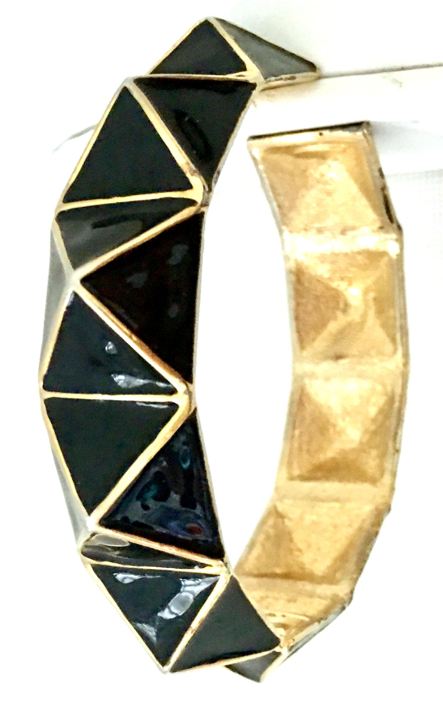 21st Century Modern Gold Plate & Black Enamel Dimensional Clamper Bangle Bracelet By, Kenneth Lane. This dimensional hinge bangle bracelet features gold plate metal with black enamel and raised geometric design. Signed on the interior, Kenneth Lane.