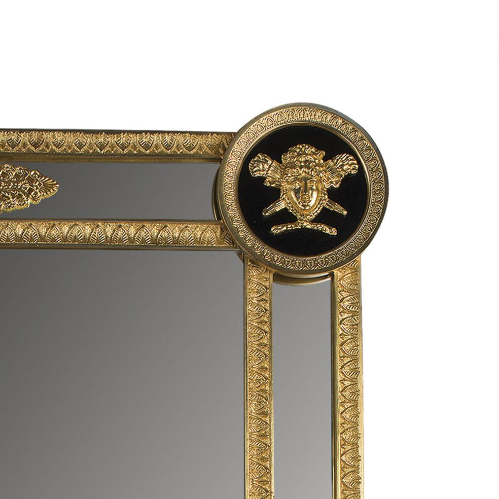 21st Century wall mirror with the golden bronze frame and with Medusa Head on the each corner. The Medusa Head are made with the lost wax technique and finely chiselled. On request to customer can modificate the metal finishing: french gold,