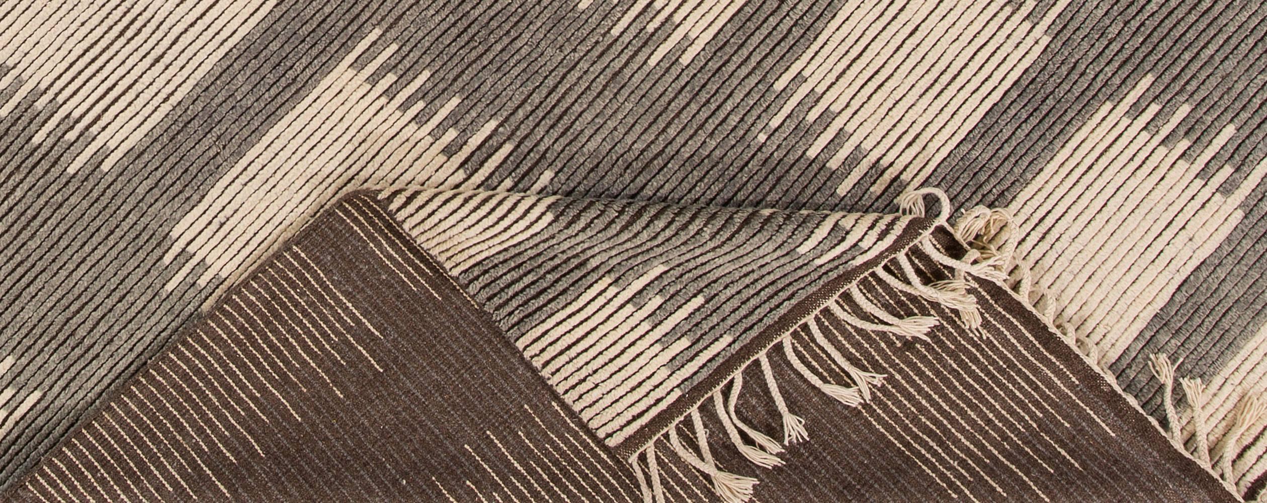 21st century contemporary Moroccan-style carpet, handwoven in India. This piece features a geometric pattern in cream on a dark brown background. This color palette creates some interesting contrast. Measures 10.05 x 14.