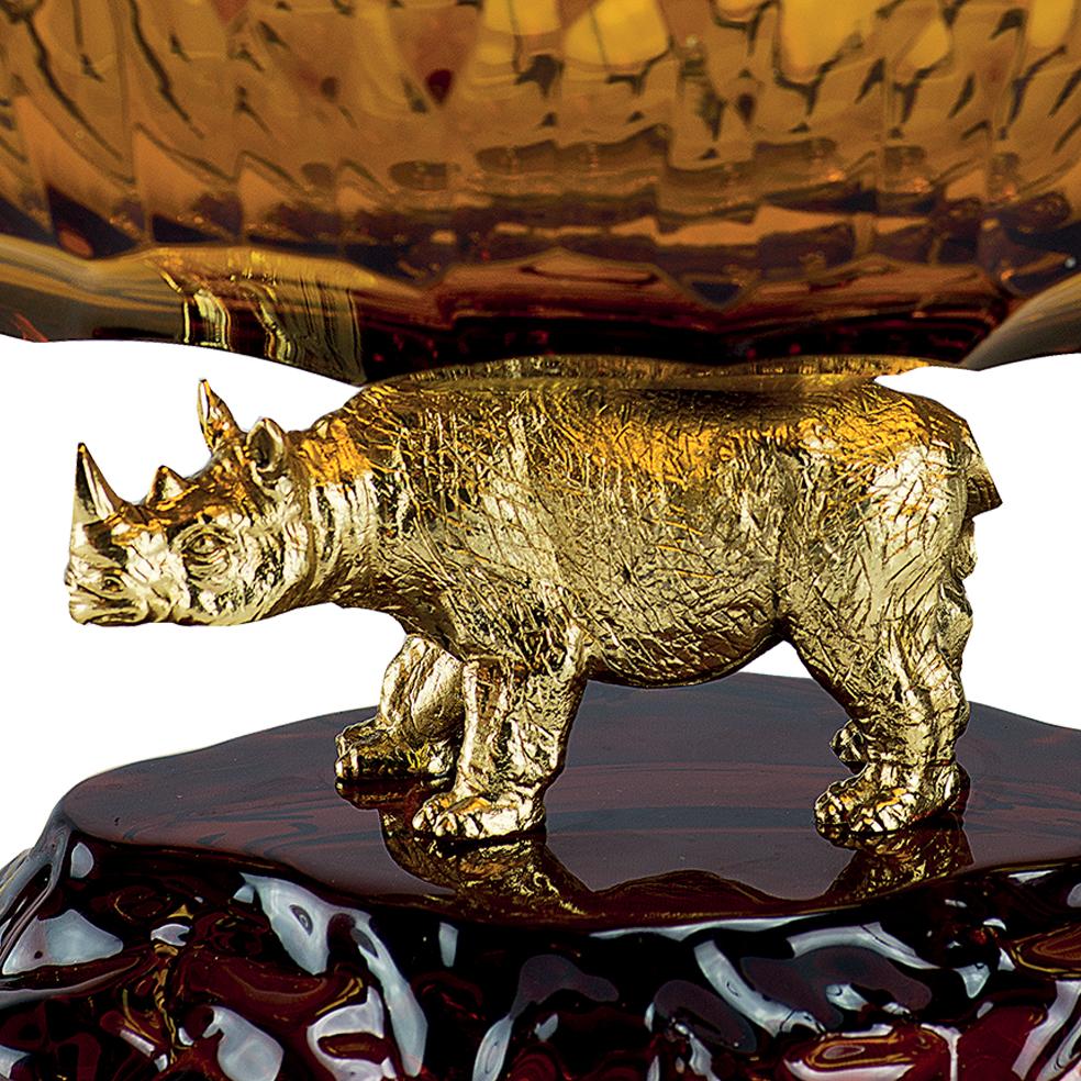 21st century hand carved amber  crystal and golden bronze bowl. This bowl is finely chiseled lost wax castings and hand-grounded crystal. The golden bronze rhinoceros on the base was created with the lost wax technique and has been finely chiseled