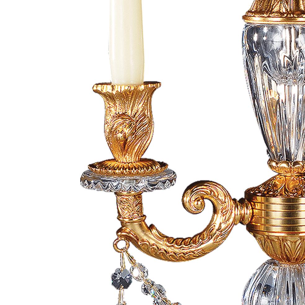 21st century hand carved clear crystal and golden bronze candelabra. This candelabra is finely chiseled lost wax castings and hand-grounded crystal. This Candelabra has got 3-flames. On request to customer can modificate the color of crystal: pink,