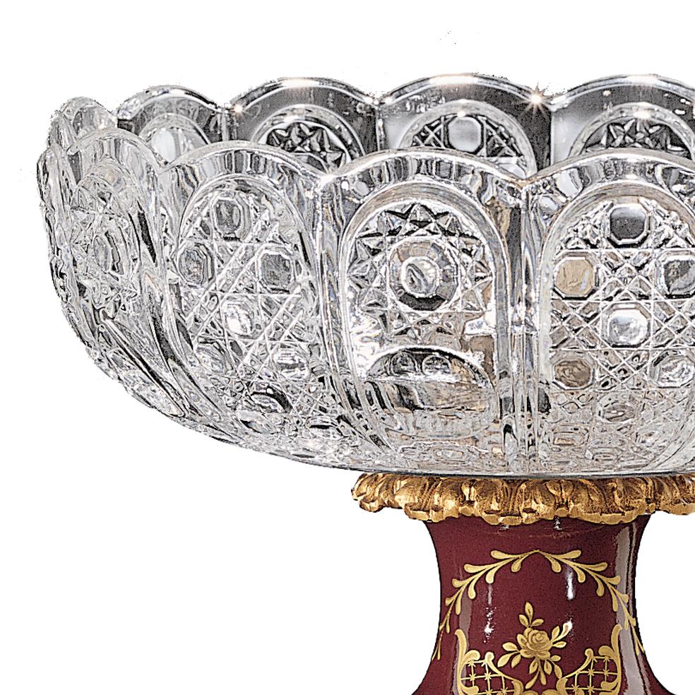 21st century hand carved clear crystal and golden bronze centrepiece. This Centrepiece has got the  porcelain base with pure gold decorations and hand-grounded crystal. On request to customer can modificate the color of crystal: pink, amber,