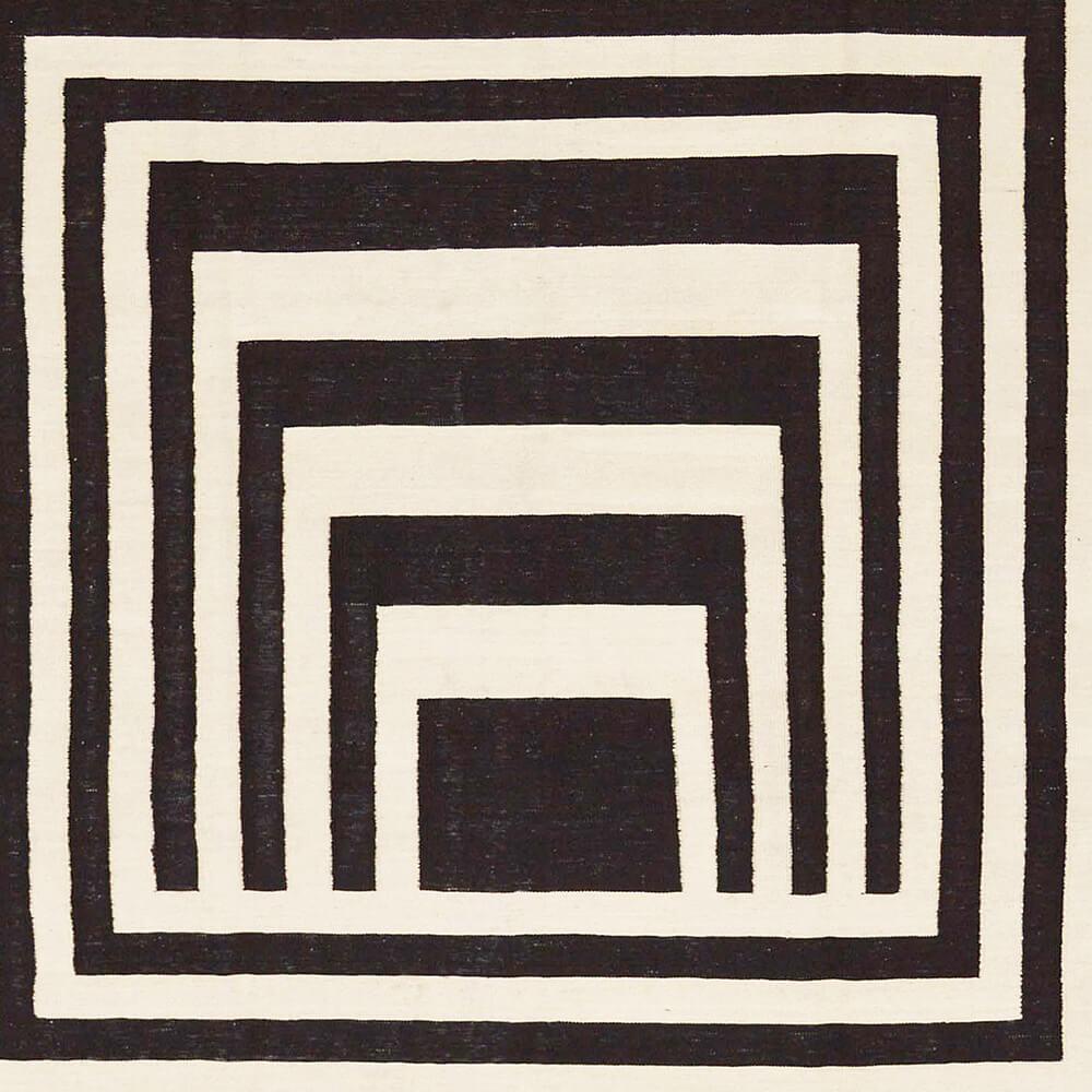 21st century handwoven modern black and white Afghan Kilim carpet

Wonderfully graphic and suitable for many furnishing styles are black and white Kilims. Modern designs are often based on traditional motifs and symbols and reinterpret them. This