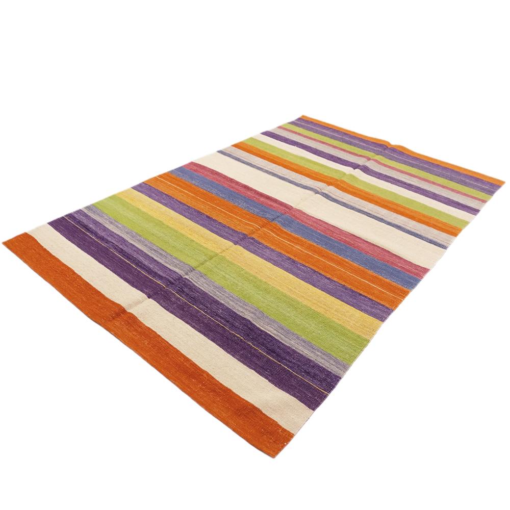 This new Kilim was handwoven in 2010 in Anatolia. The flat-woven kilim captivates with its bright colours with a focus on orange, purple and beige. It makes any room fresh and gives a cheerful atmosphere.