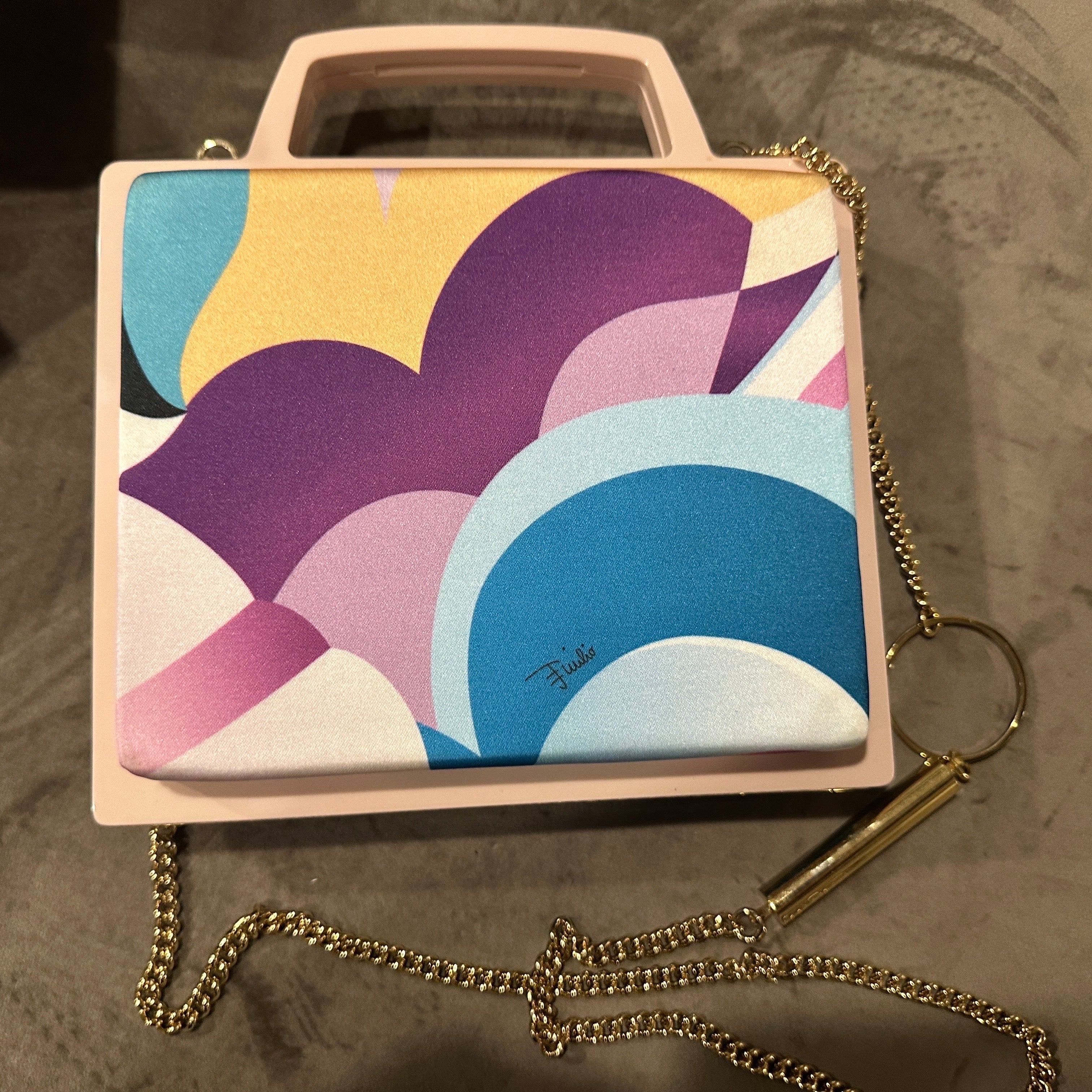 This 21st-century Haute Couture silk shoulder bag by Emilio Pucci is a vibrant testament to the brand’s legendary affinity for bold prints and Italian sophistication. This piece embodies Pucci's legacy of merging art with fashion. Known as the