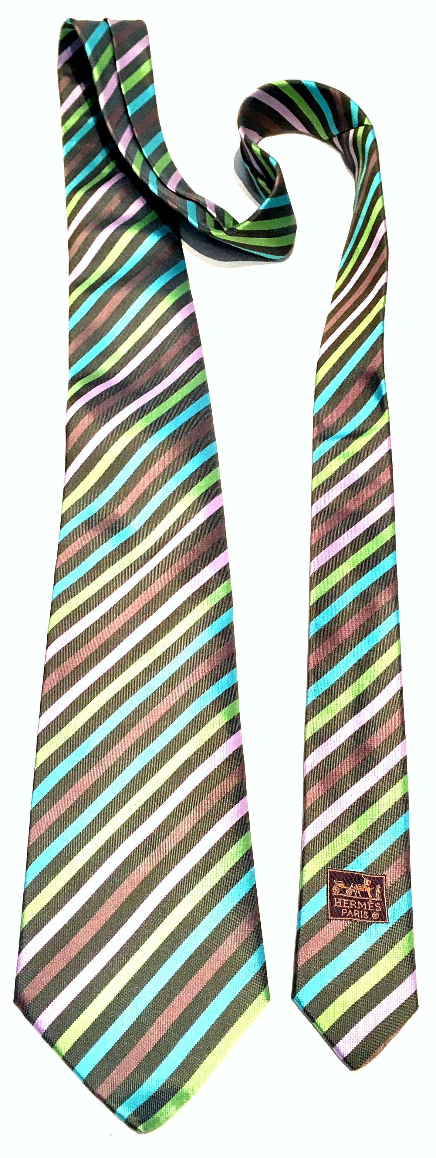 Contemporary Hermes Paris diagonal striped silk tie. Features a grey ground with pink, lime, lavender and turquoise stripes. Original authentic Hermes tags intact. Serial number reads, 758610T.