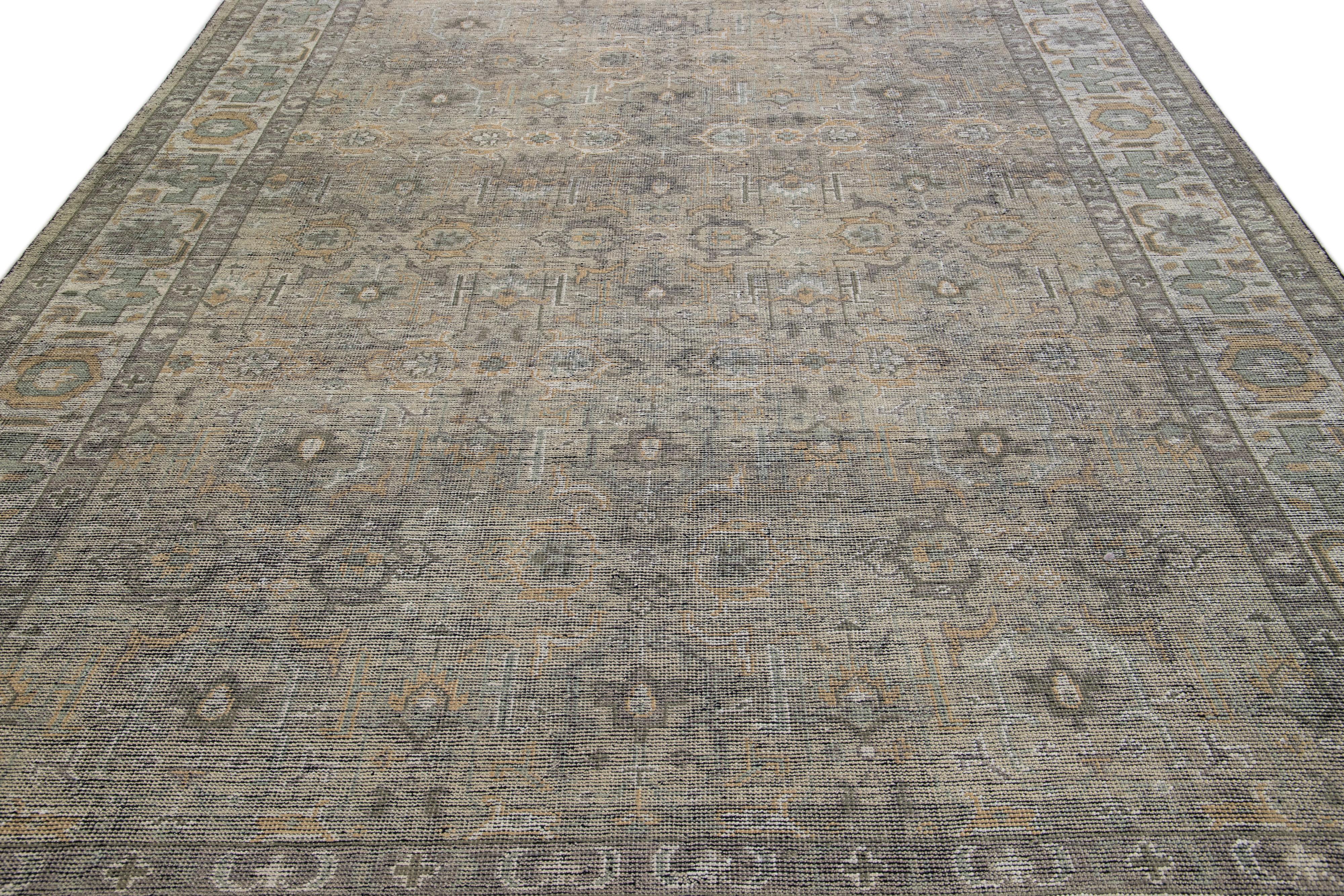 Beautiful contemporary Oushak rug, hand knotted wool with a tan field, ivory and green accents in an all-over Classic motif, circa 2019.
This rug measures 9' 2