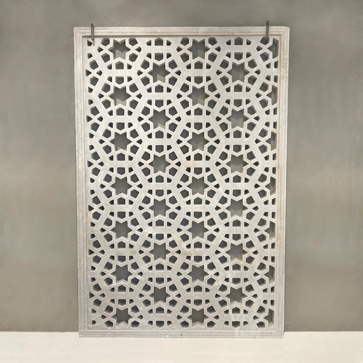 Un pannello in marmo bianco intagliato a mano con una stella geometrica e un disegno Jali. Questo pannello architettonico artigianale può essere utilizzato come piano d'appoggio, diffusore di luce, finestra a cielo aperto, schermo per la privacy o