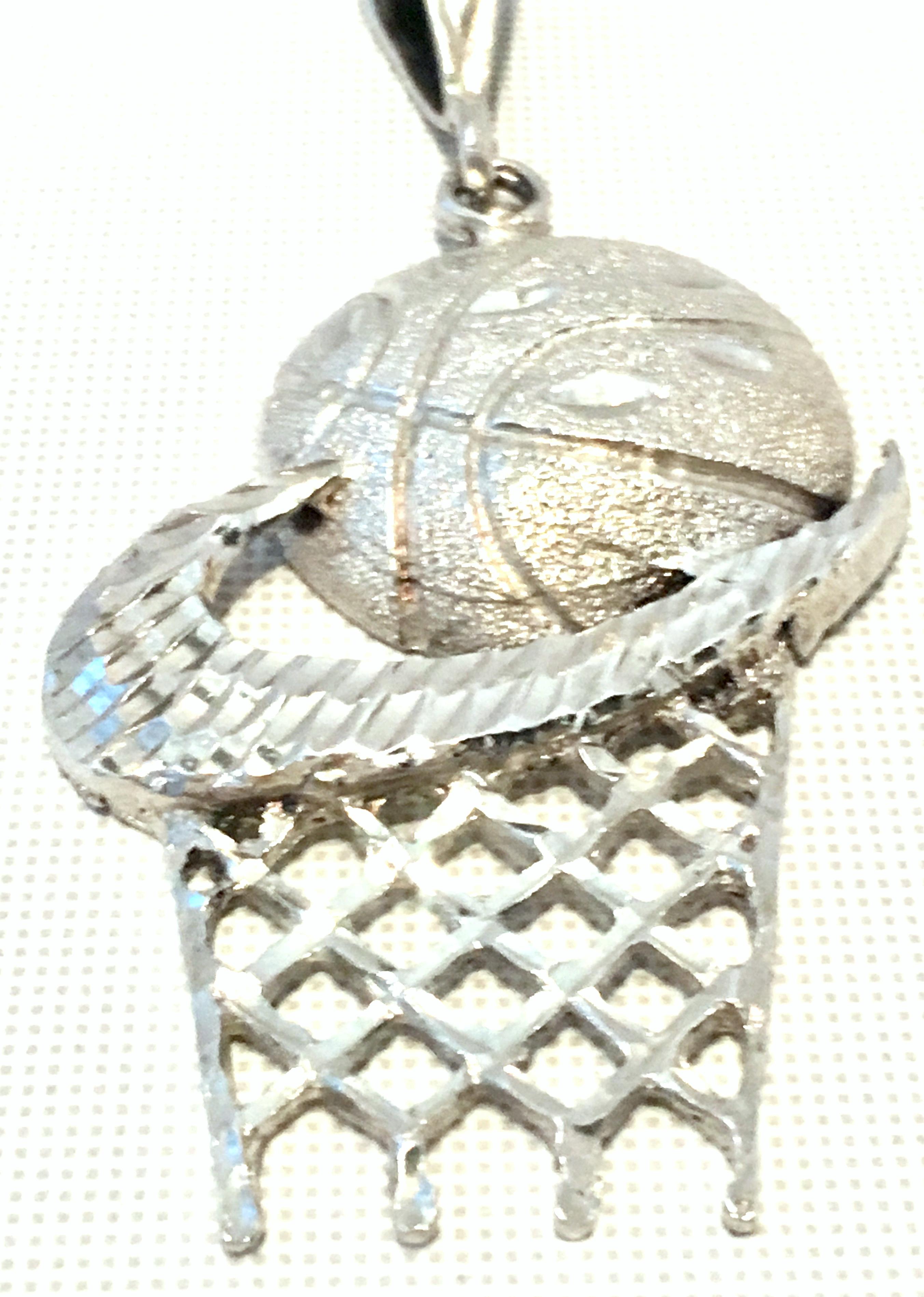 silver nike pendant