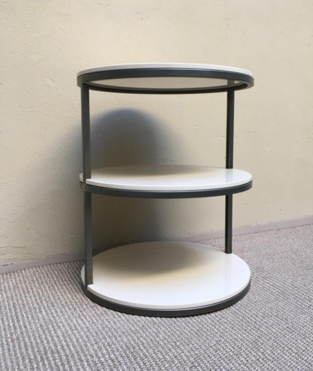 This engaging  side table has a contemporary shape with the round wooden lacquered shelves. The slim structure is in burnished iron. It is a piece totally made and designed  in Italy.
The three shelves are removable and they are lacquered in a very