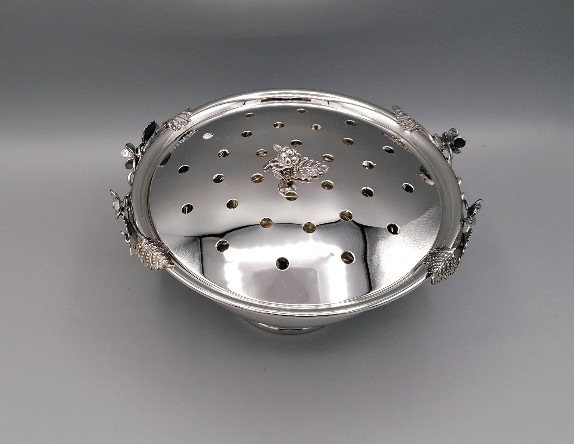 Caja para flores de plata de ley 925 maciza, lisa y redonda, con base.
La tapa perforada tiene un pomo en fusión con mora y hoja,
En el borde del cuenco está decorado con moras y hojas realizadas en fundición de plata.
El objeto perforado en la