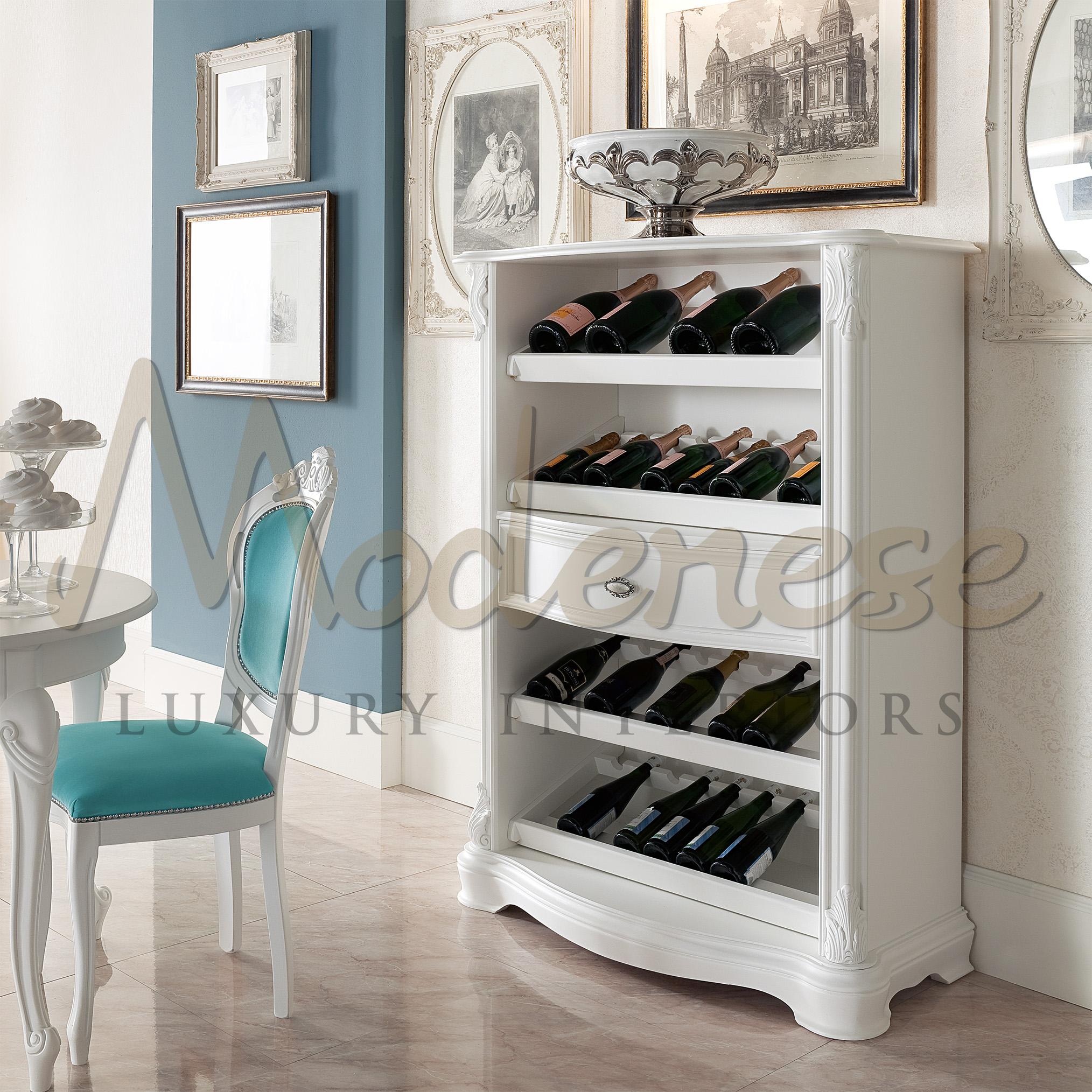 A lot more than just a normal furnishing accessory, this bottle rack by Modenese Luxury Interiors features one drawer and four shelves capable of holding at least 30 bottles. White wood colour is given by a lacquered finish and baroque carved