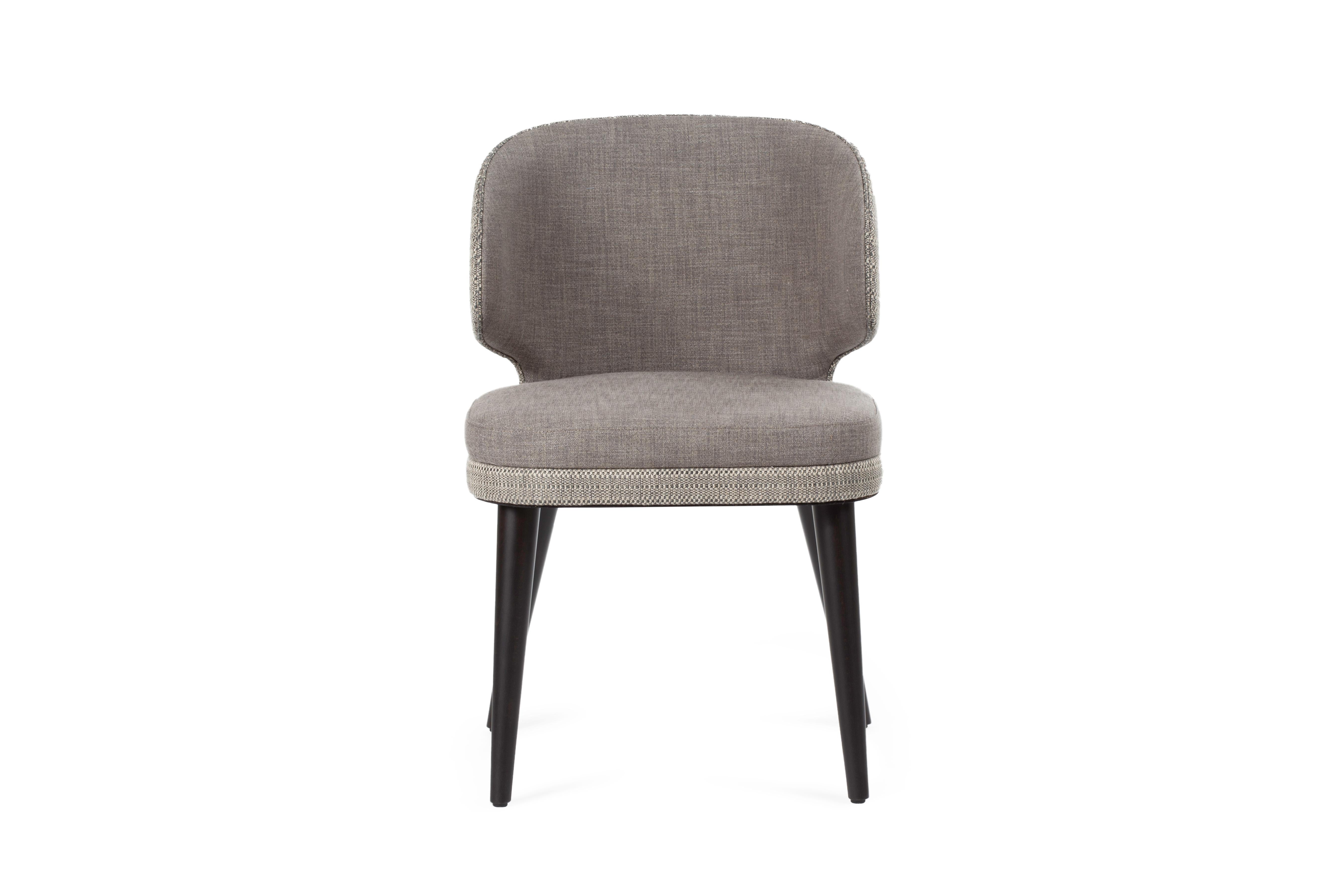 Soft, enveloping forms characterize the Kuo chair. Elegant combination of grey and black make this chair perfect for any interior. 

Features
Chair with upholstered seat and backrest covered in fabric with special stain-resistant treatment that