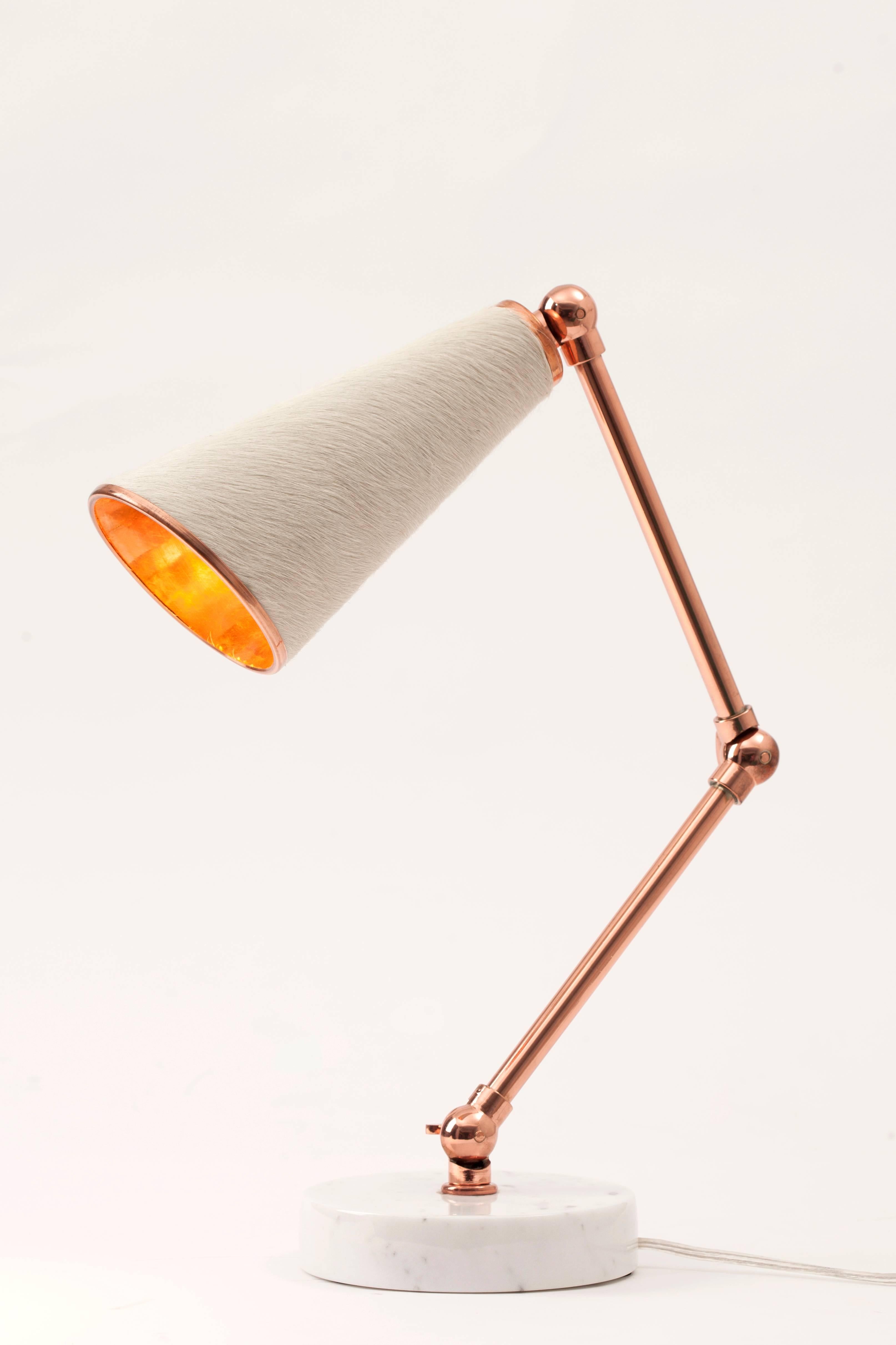 Lanterna is a new age robot lamp with a heart. Unique textured materials such as felt, cork and cowhide are combined with white and black colored marbles and shiny metals such as brass and copper. Adjustable arms of Lanterna enables users to justify