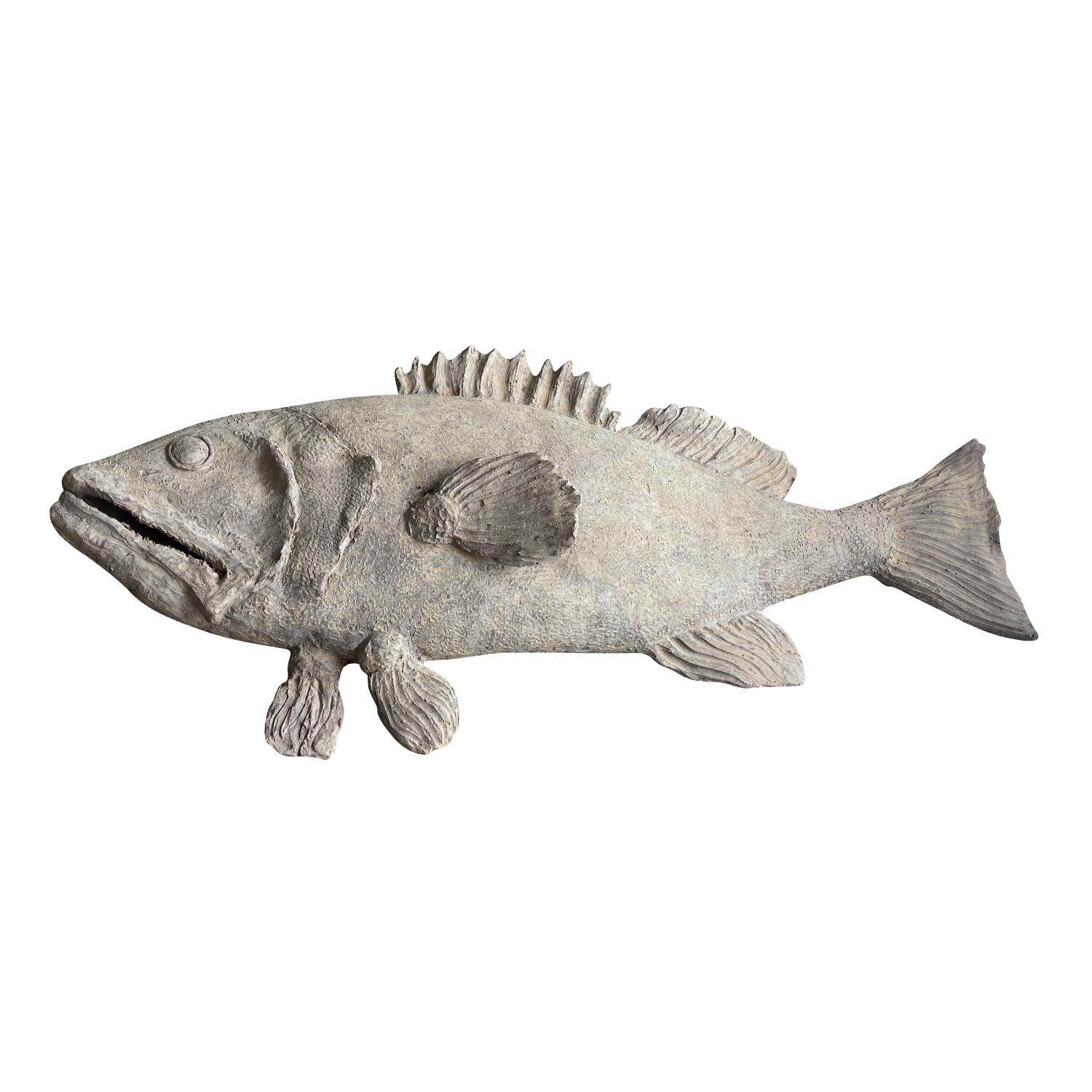 A large terra cotta fish statuette from Tuscany. This magnificent handcrafted fish is facing toward the left and features handmade details. Wear consistent with age and use. Circa 21st Century, Italy.