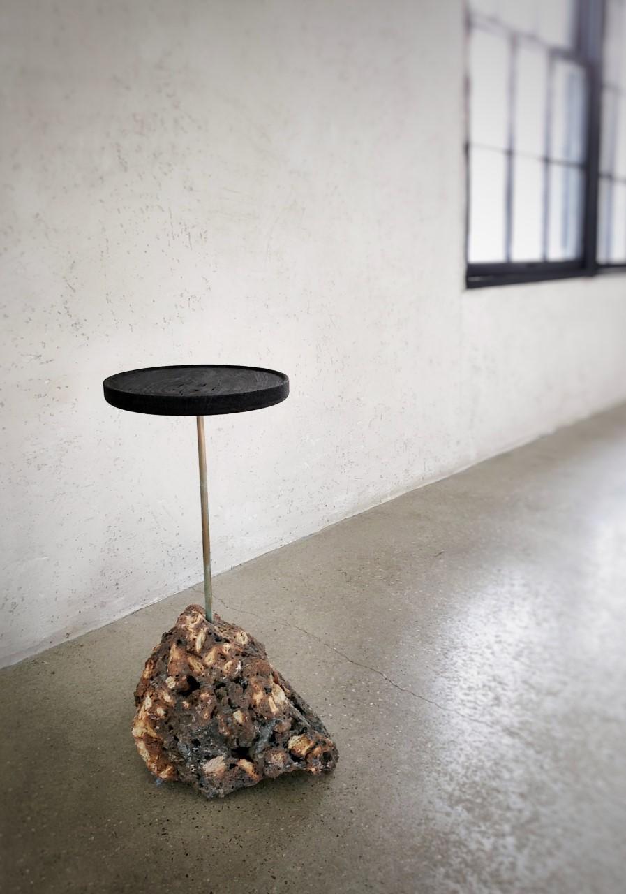 Side table with black top and Lava base by designer and furniture maker Michael Javidi. As seen in the pictures is available now. 

Made to order: 
- All base/rocks are unique. Each one would be different from each other. 
- The tops can also be