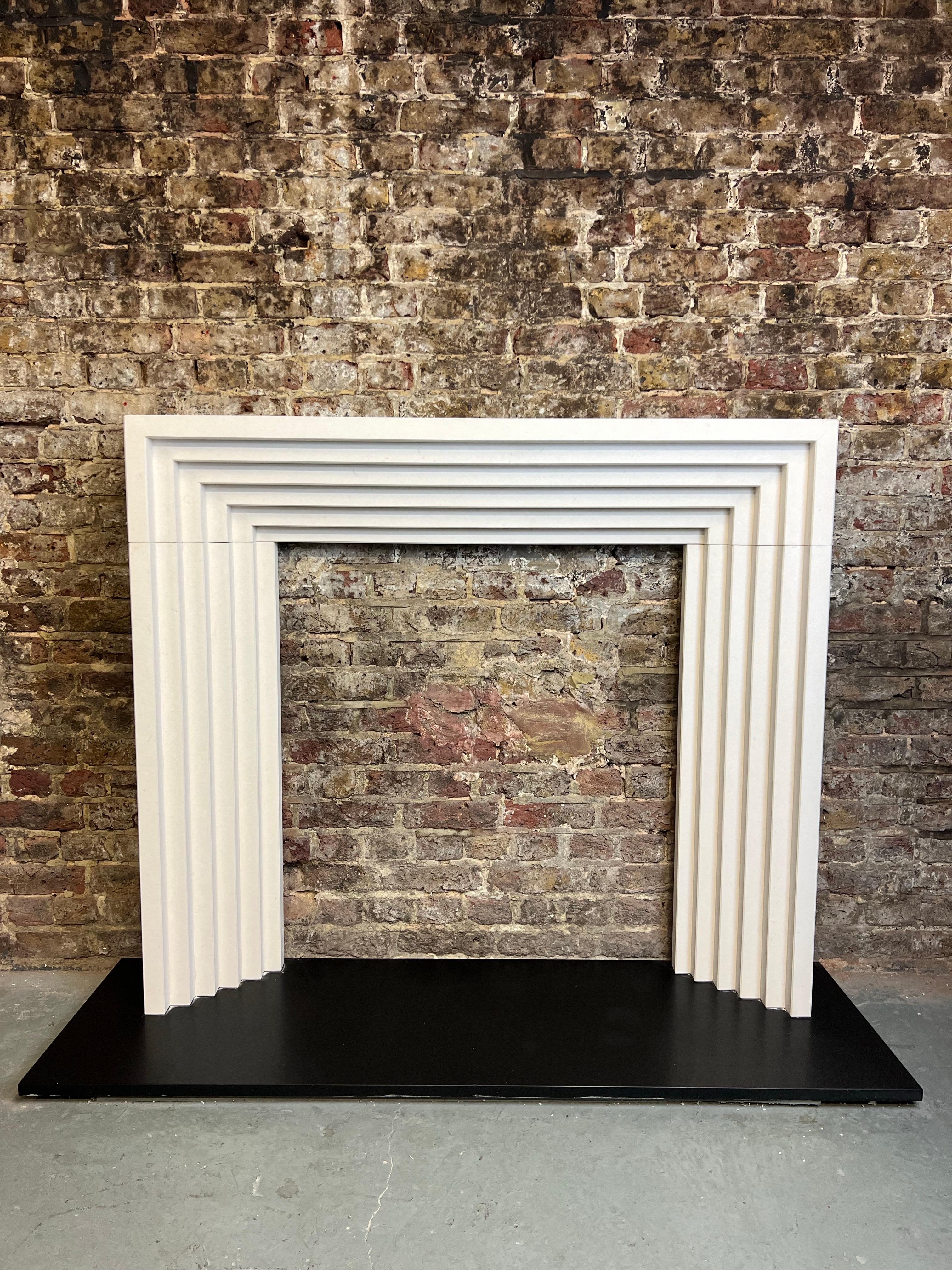 21st Century Limestone Fireplace Mantlepiece.  
A Stylish Contemporary Limestone Surround Based On An Art Deco Style.
6 Stepped Hand Carved Limestone Tiered Fireplace, Made From The Finest Agean Limestone.

Dimensions:
Width 54
