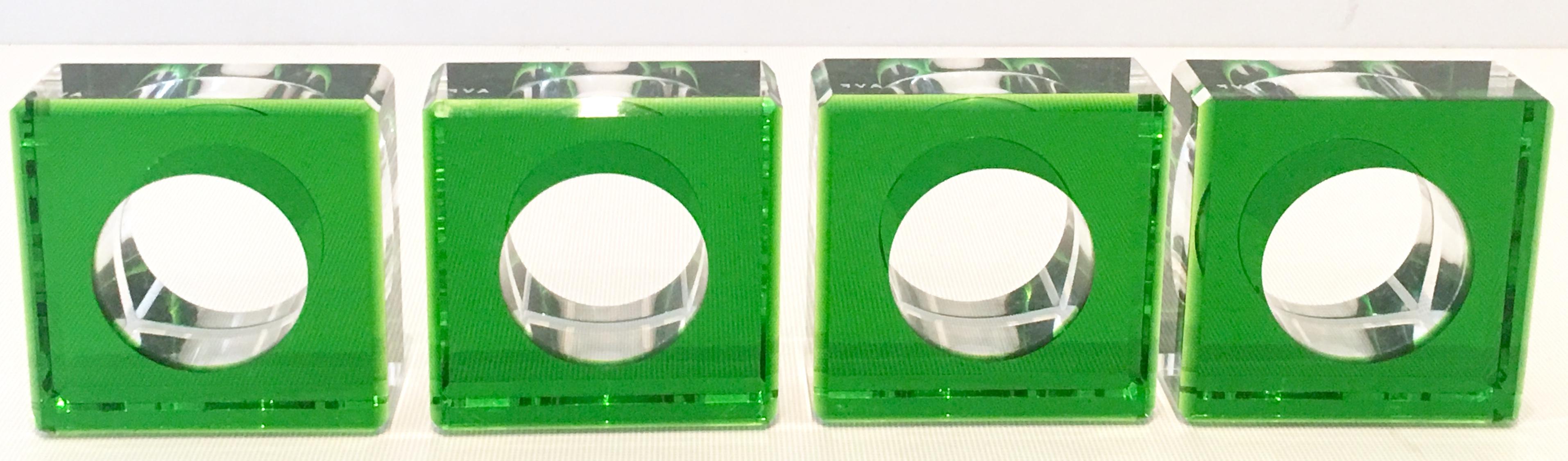 21st century and new modern round and square vibrant emerald green set of four cased Lucite napkin rings by, Alexandra Von Furstenberg. Each of the four brilliant cut and faceted napkin rings, signed in the Alexandra Von Furstenberg (AVF) white font