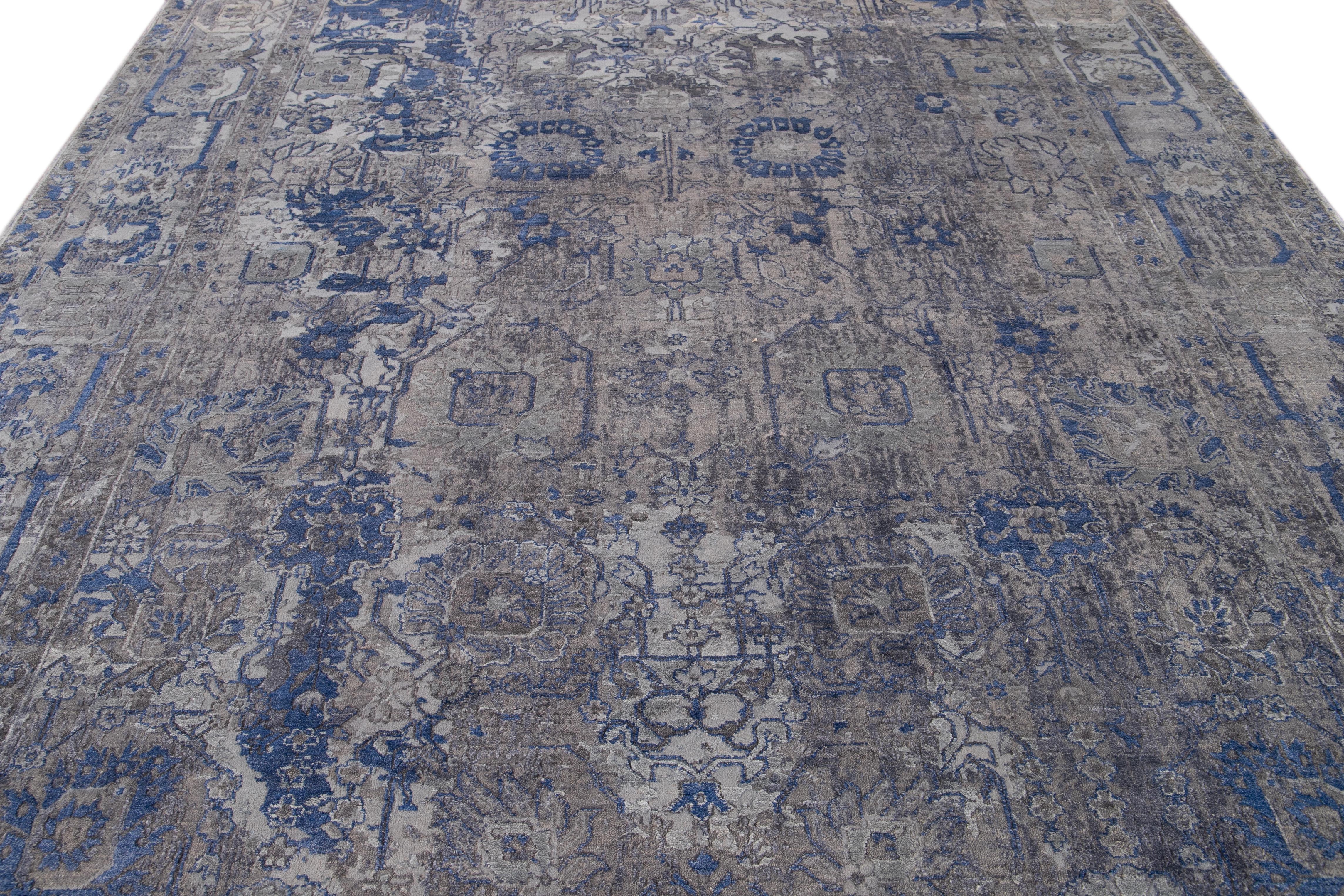 This exquisite rug features a refined combination of wool and silk, highlighting a mesmerizing abstract pattern embellished with graceful hues of blue and silver, artfully encompassing a captivating gray backdrop.

This rug measures 8'11