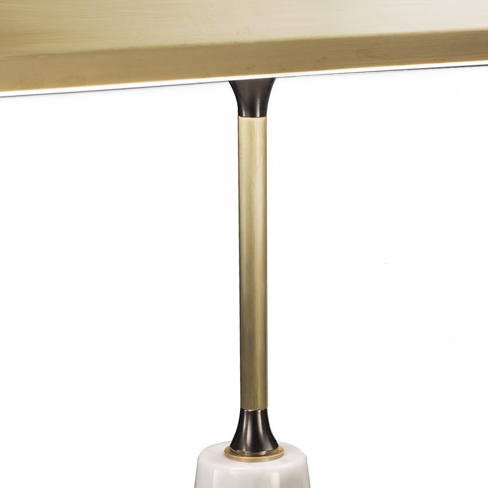 1-light table lamp in burnished brass and base in white veined marble. Each object is handcrafted and the care for every detail makes each item unique in its kind.
This table lamp is contemporary in style.  It has a simple and elegant design and