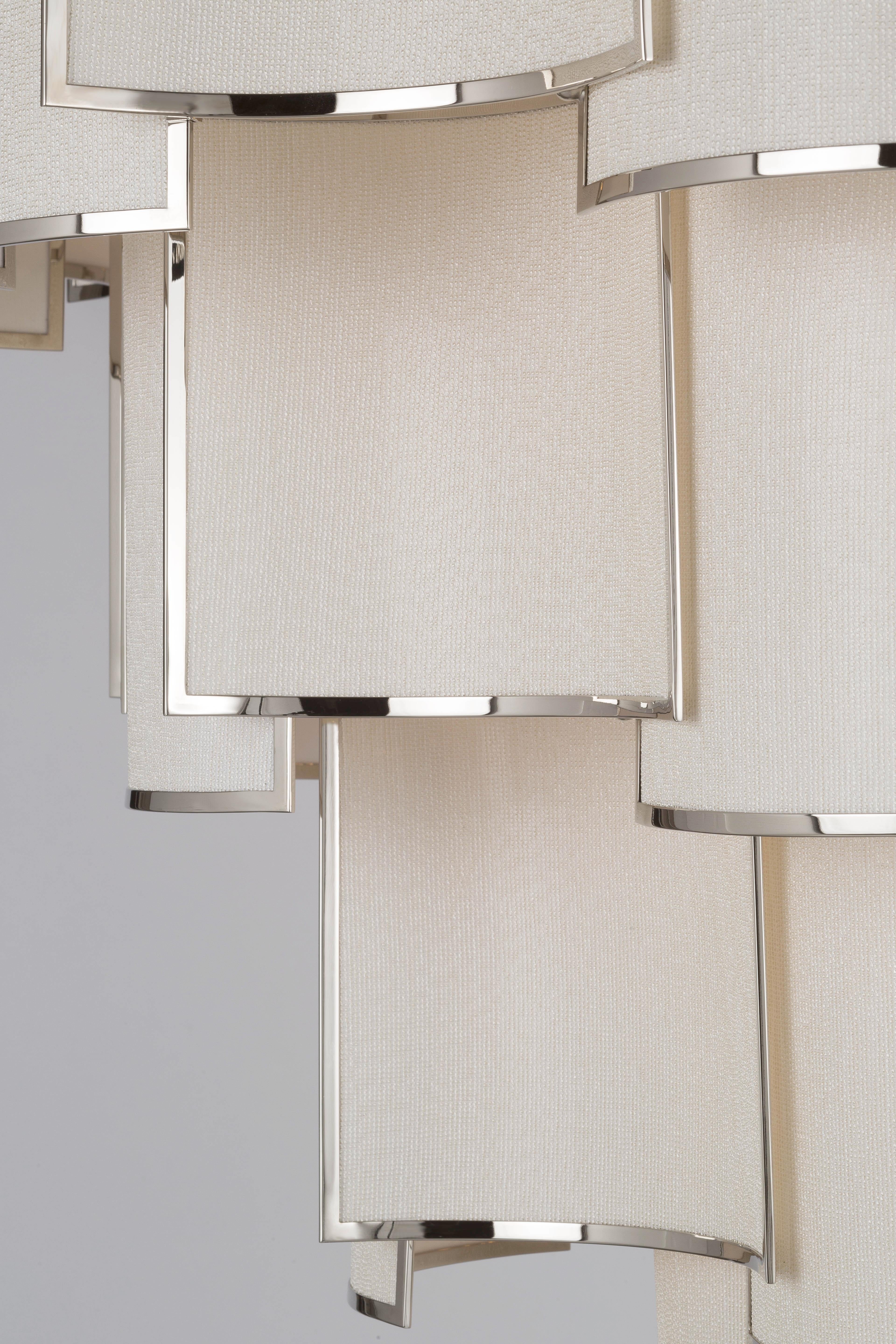 Shade Collection - A composition of small curved framed panels that create a luminous movement, also available in other finishes and fabrics, as well as sizes. All Officina Luce items are customizable.

Main structure in polished nickel finish;