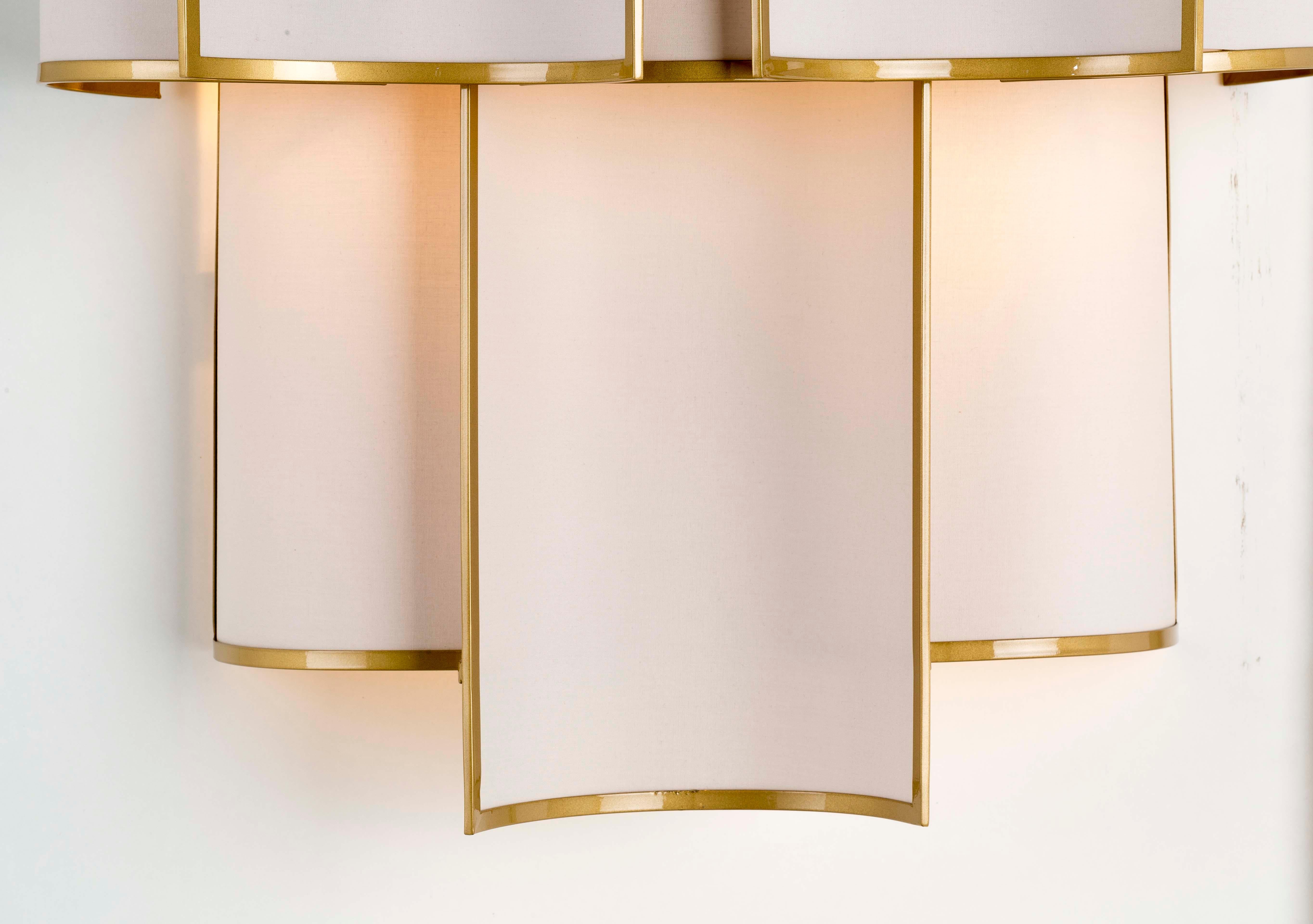 Shade Collection - A composition of small curved framed panels that create a luminous movement, also available in other finishes and fabrics, as well as sizes. All Officina Luce items are customizable.

Main structure in natural brass in satin